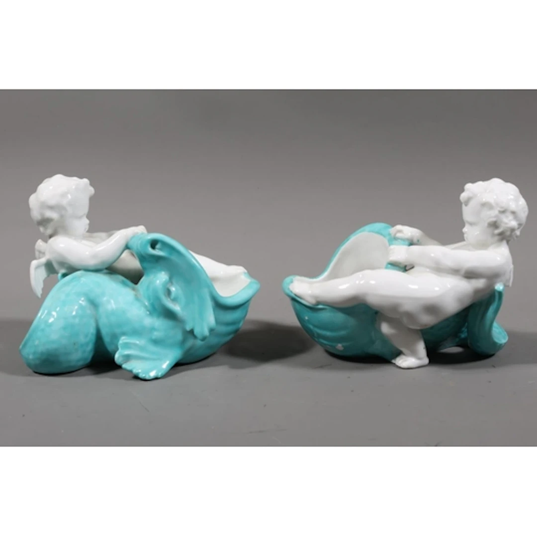 Pair of cache pots modelled as putti and sea serpents. ...