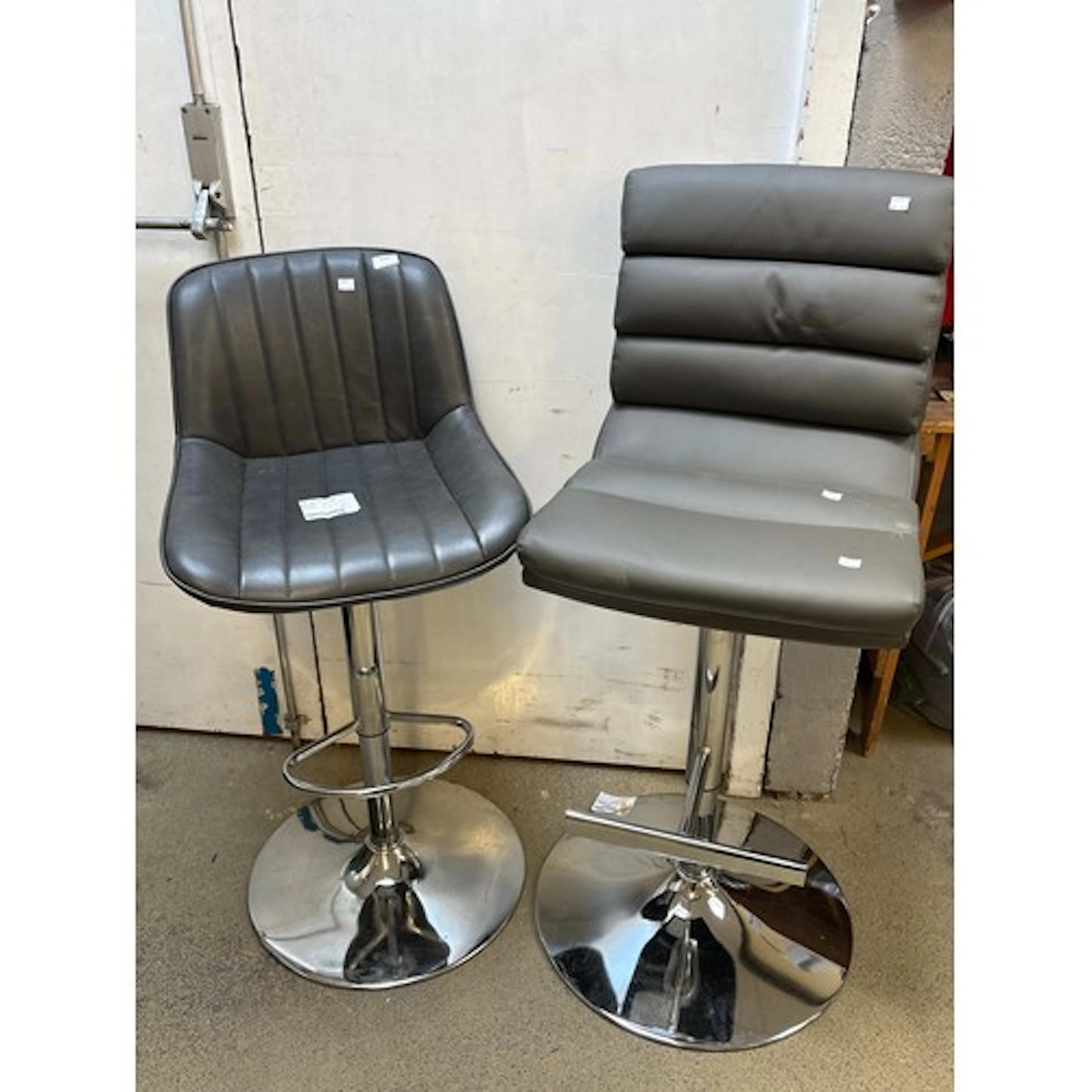 A Bayside grey gas-lift bar stool and a grey gaslift bar sto...