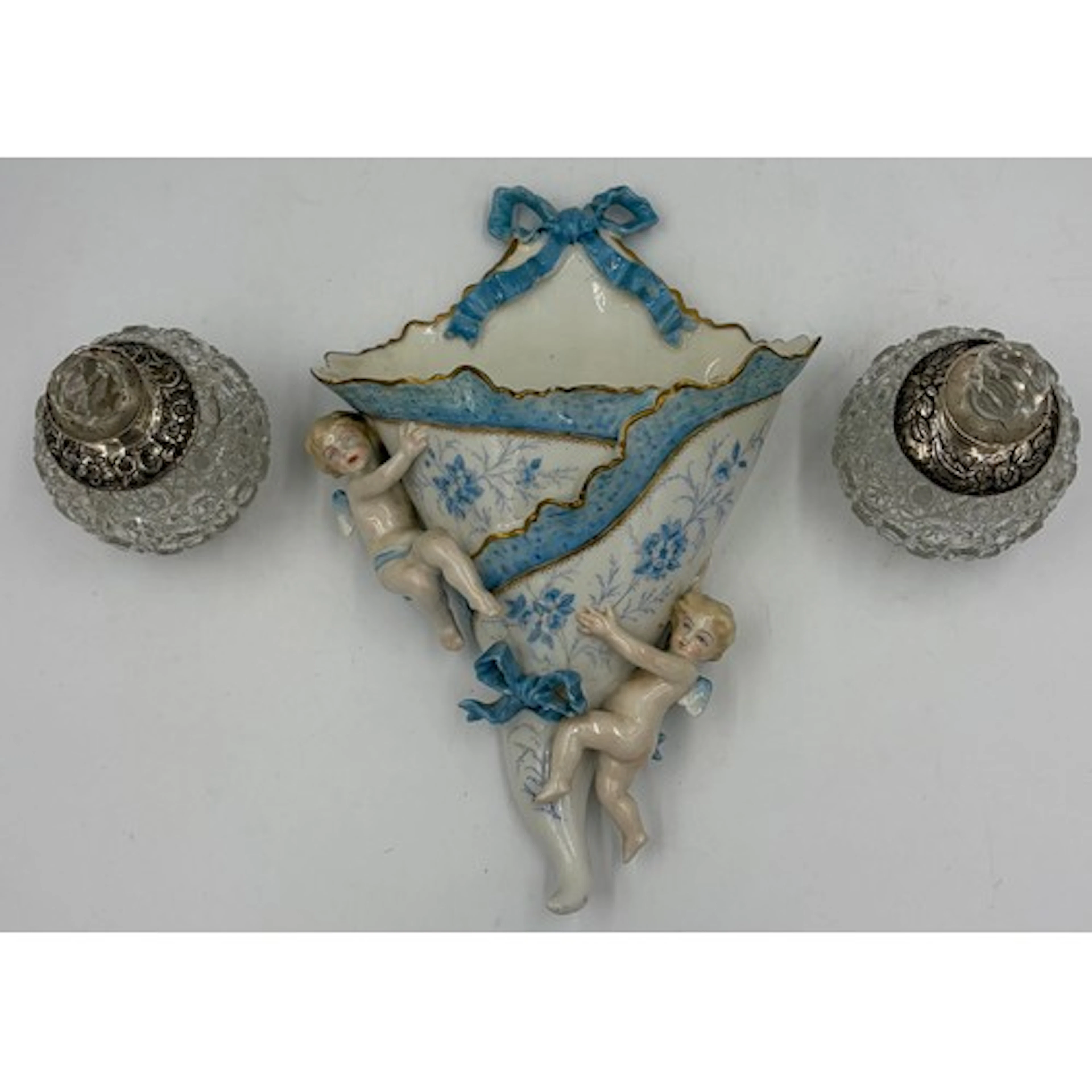 A Continental ceramic wall pocket with cherubs, 30cm h toge...