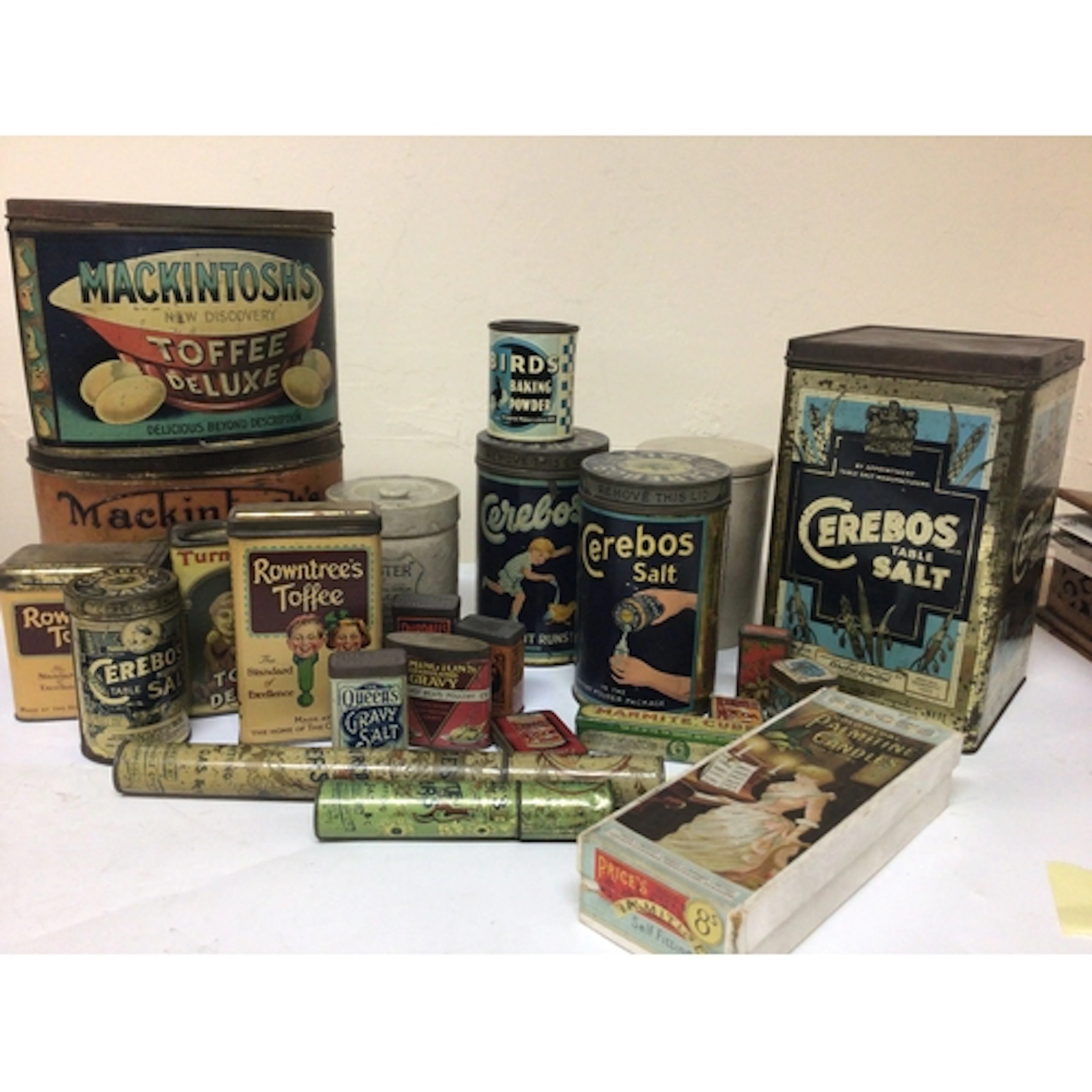 A box containing Vintage kitchen tins Toffee tins cera...