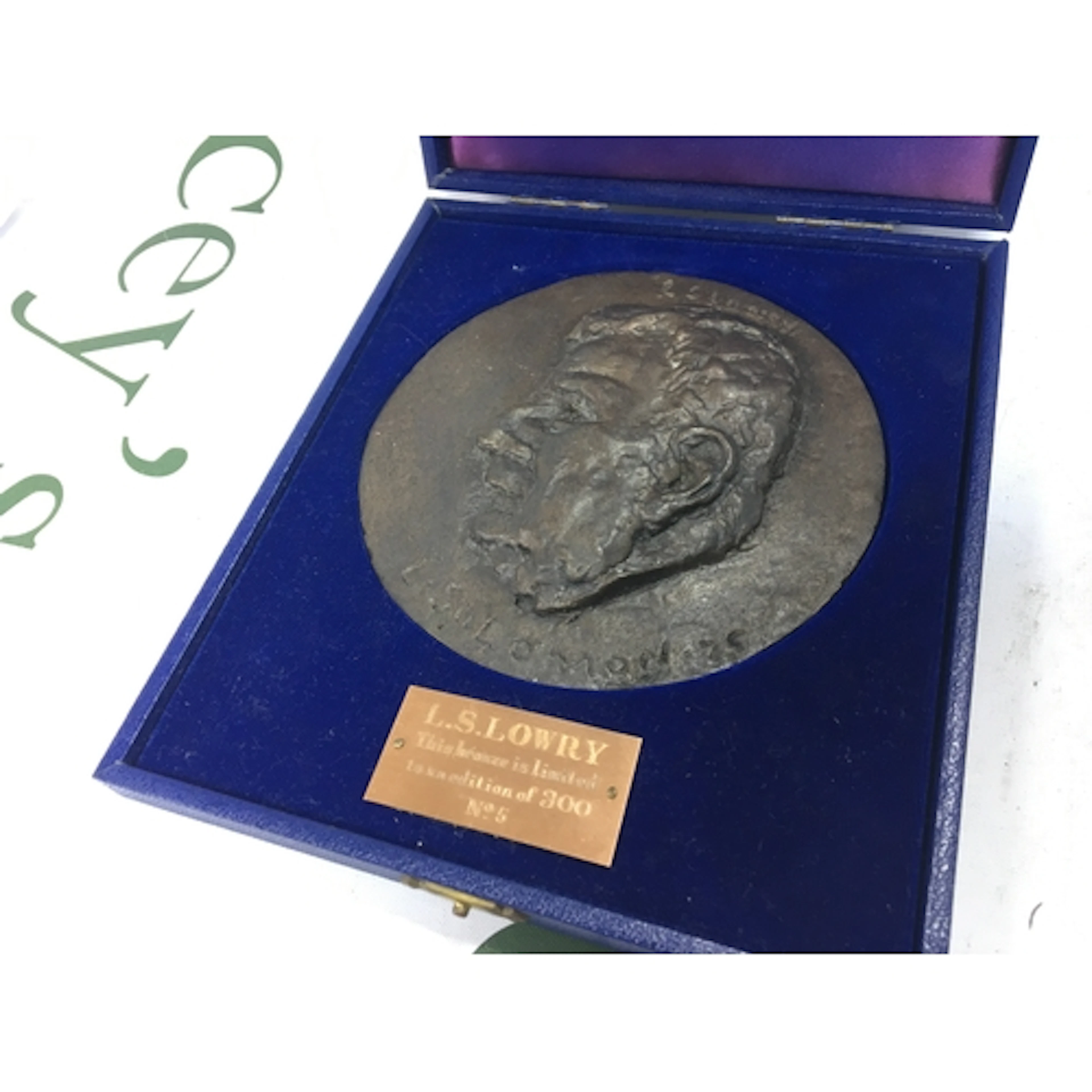 A good boxed bronze head Round plaque of L.S Lowry in a fitt...