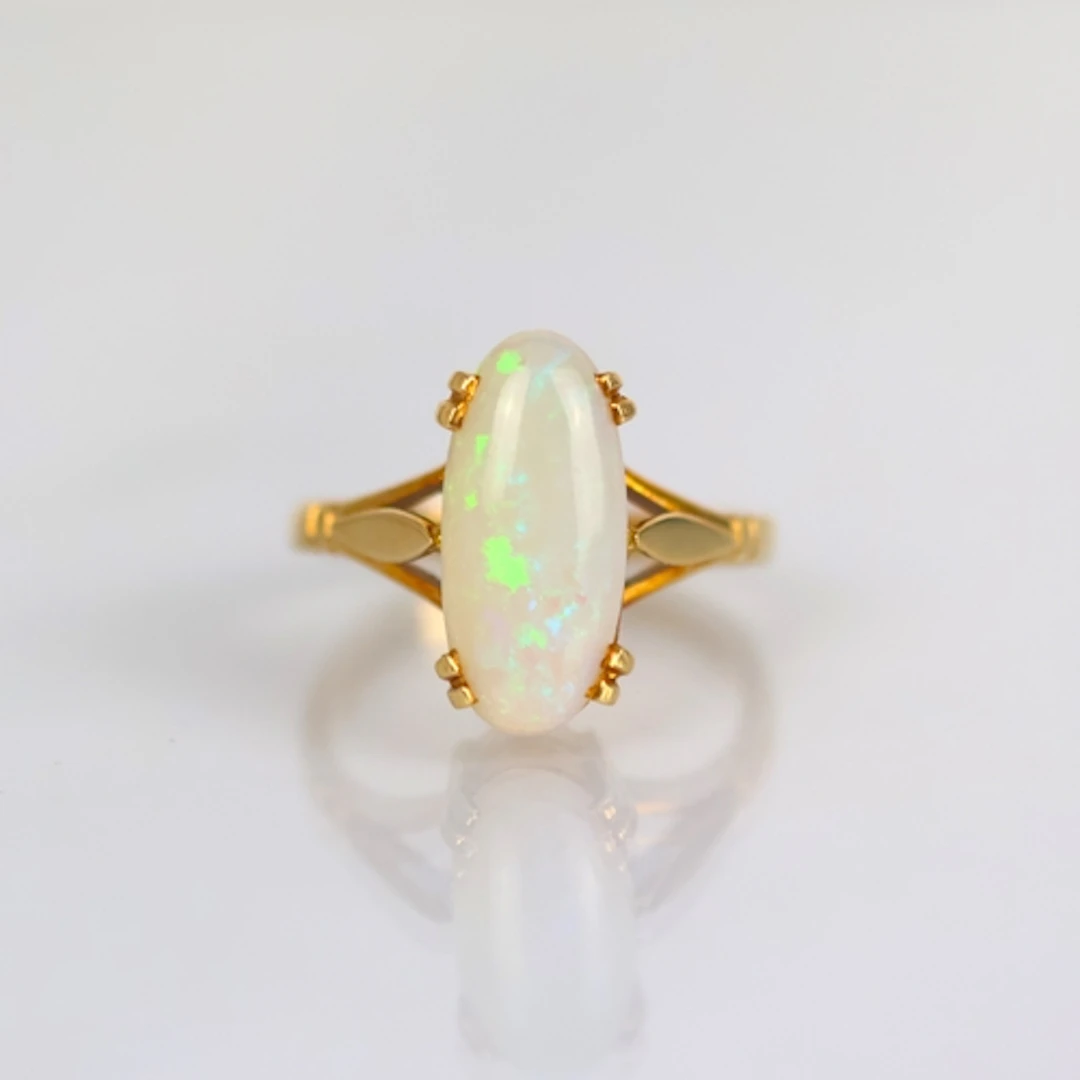 An early 20th century style opal ring, the oval opal cabocho...