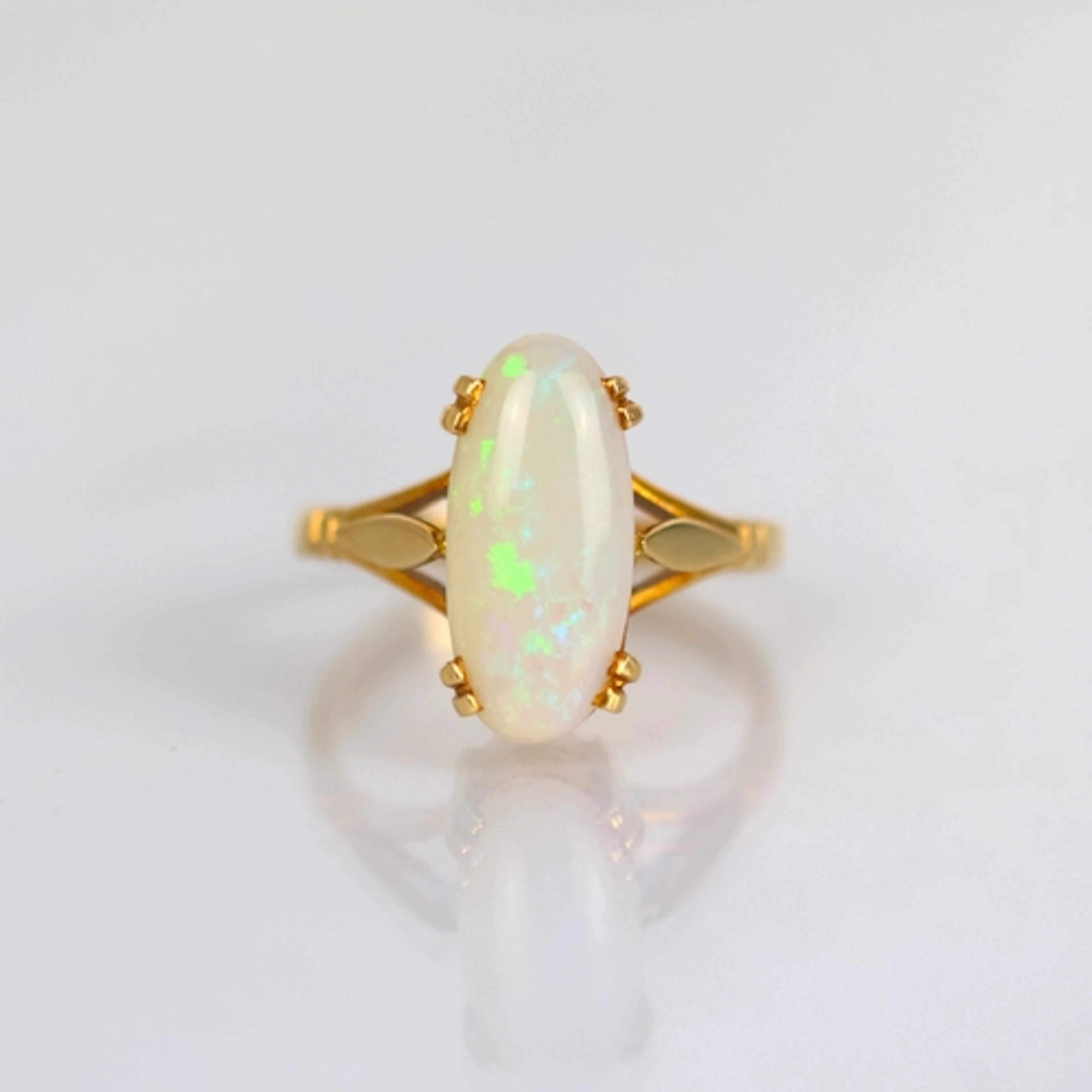 An early 20th century style opal ring, the oval opal cabocho...