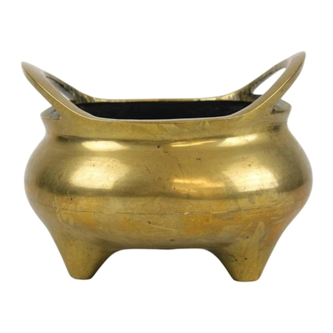 An African brass torque. With engraved decoration and scroll...