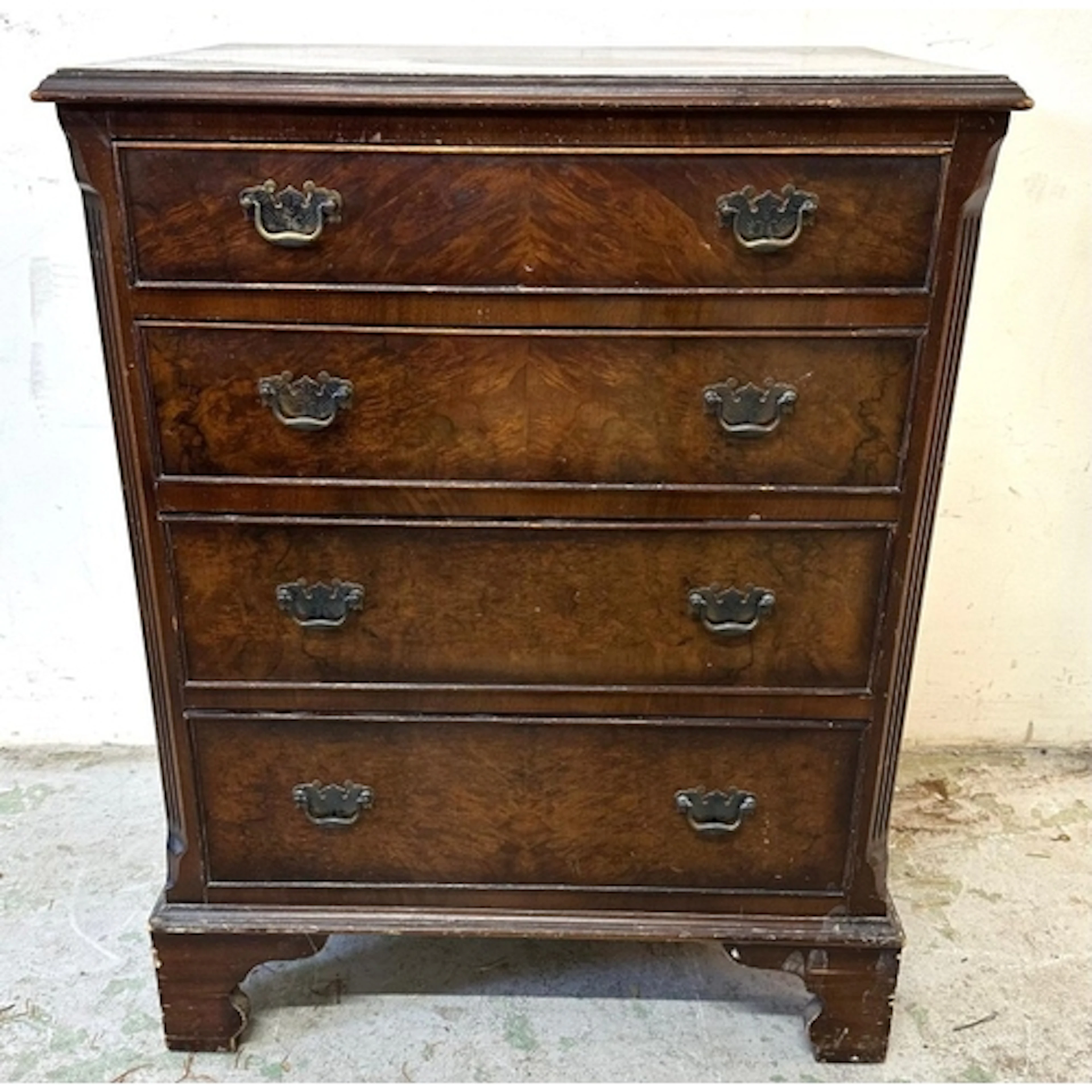 A Georgian style four drawer chest of drawers with swan neck...