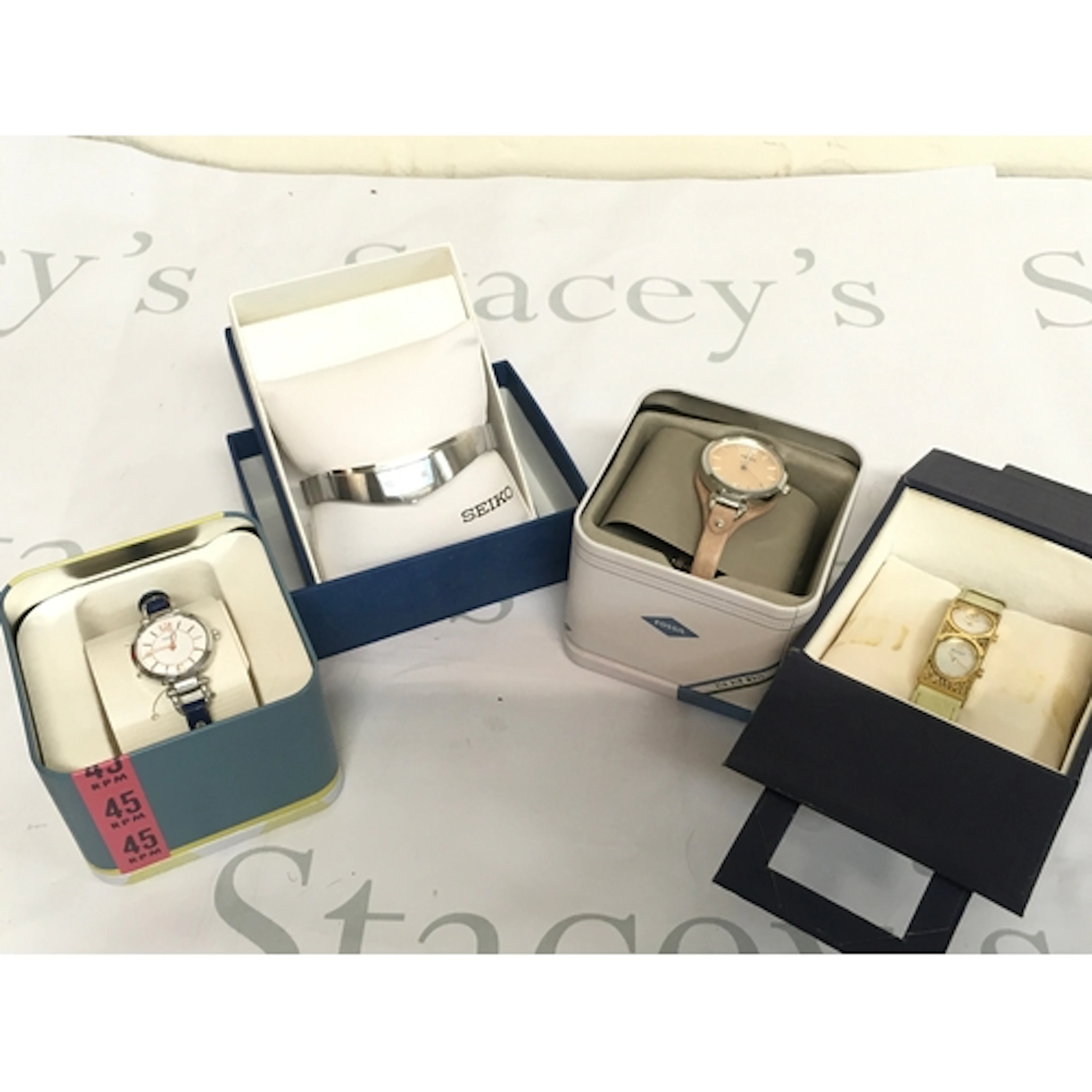 Four boxed watches including Fossil, Seiko, Pierre Lannier