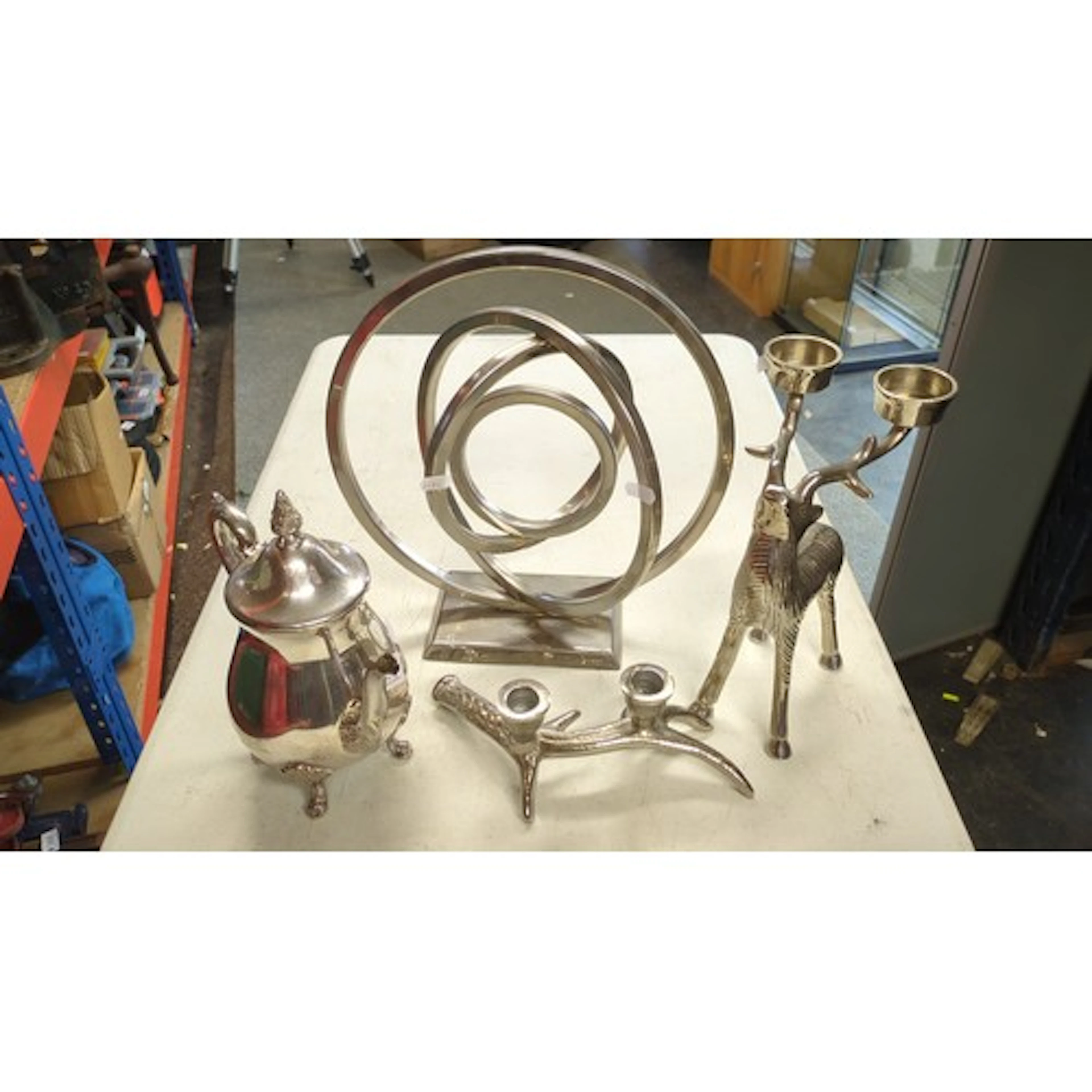 A group of modern silvered metal decorative wares comprising...
