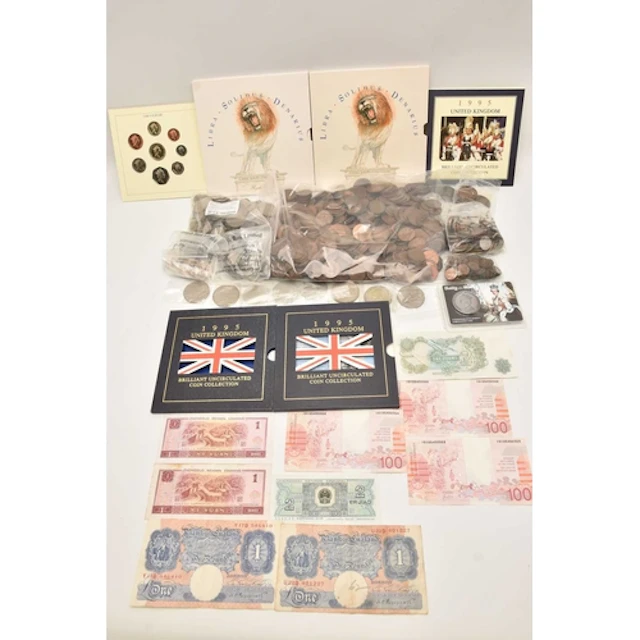A plastic case containing coins and banknotes. Noted are 2 x...