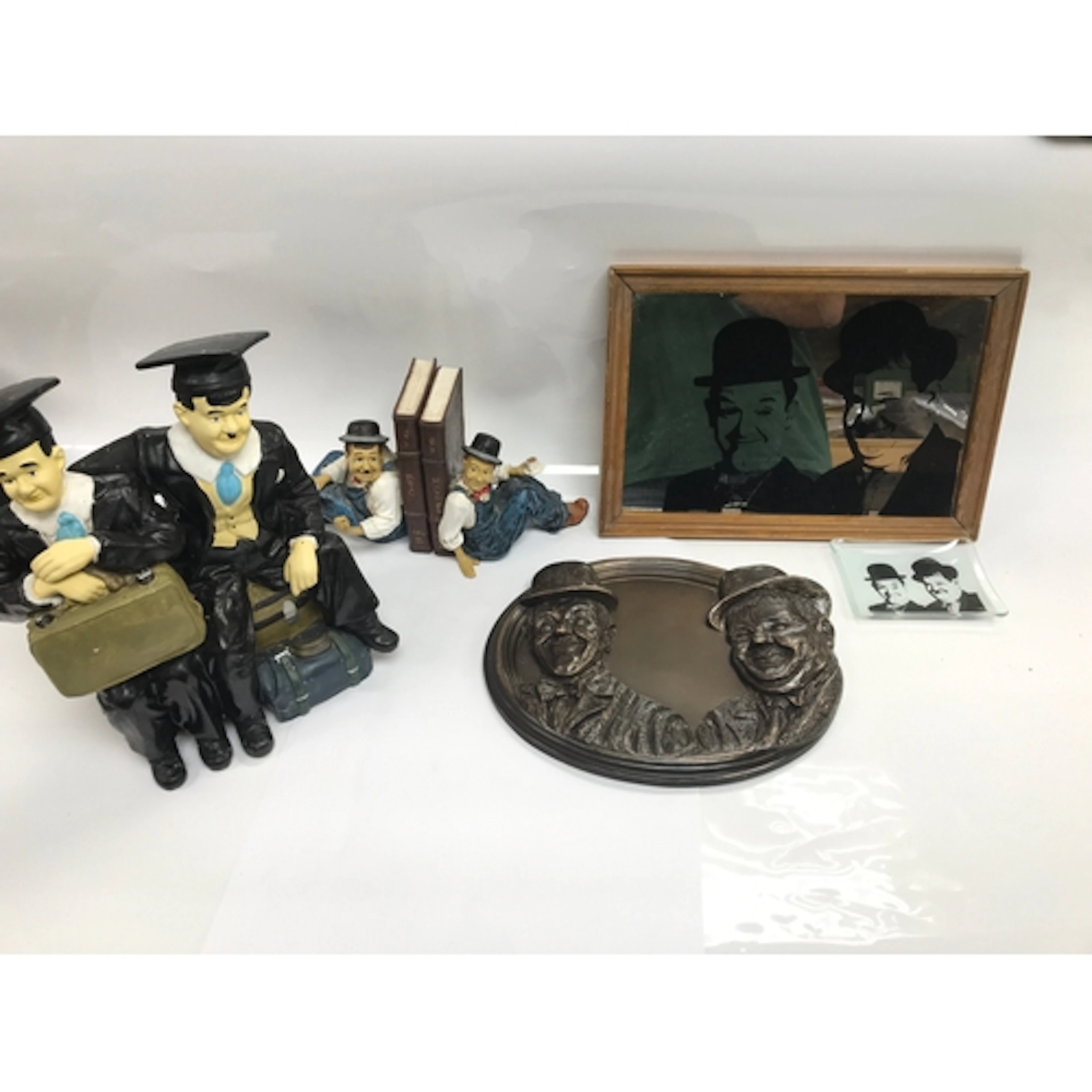 Collection of Laurel and Hardy items including oval wal...