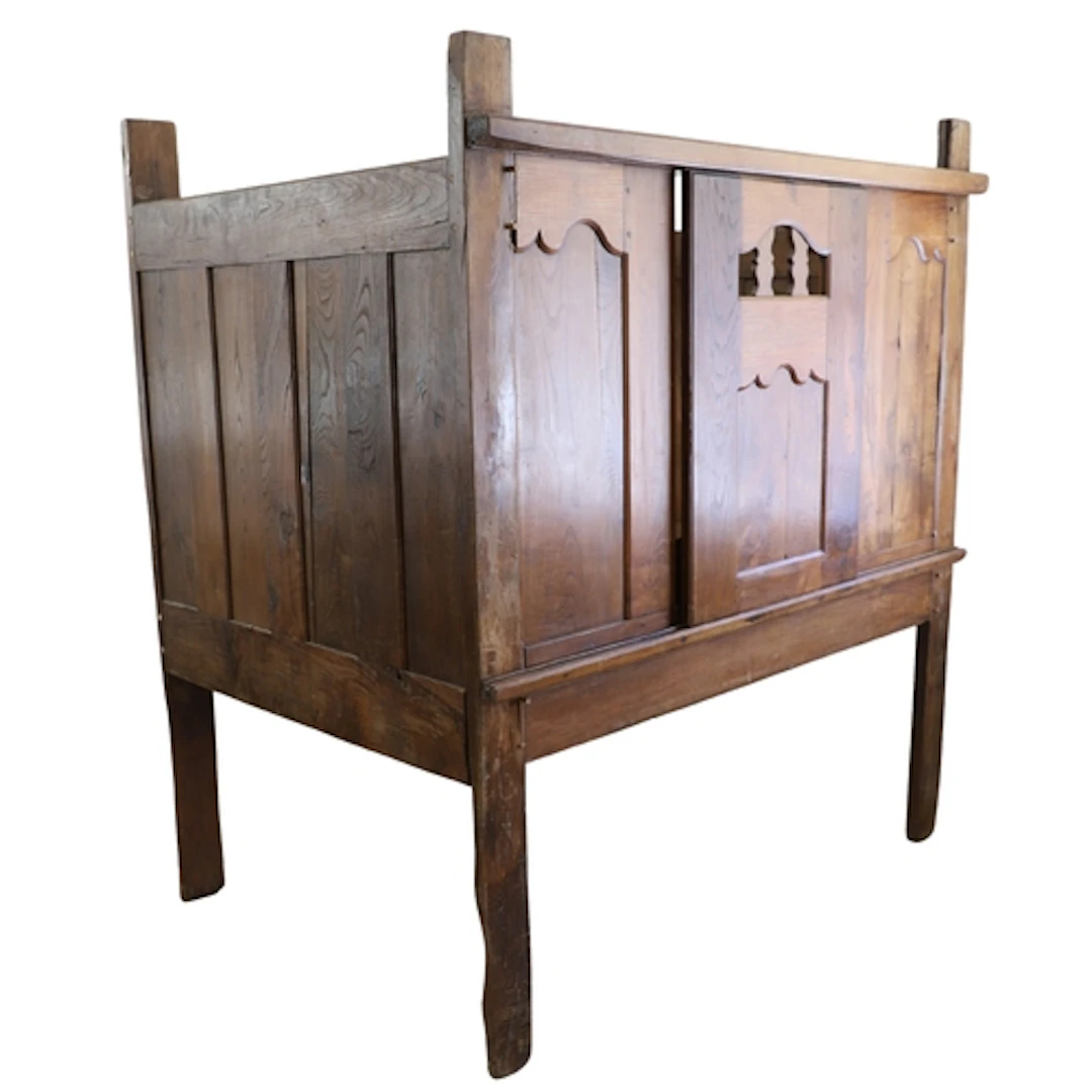 AN ANTIQUE FRENCH BRETON OAK BED. with panelled front and sl...