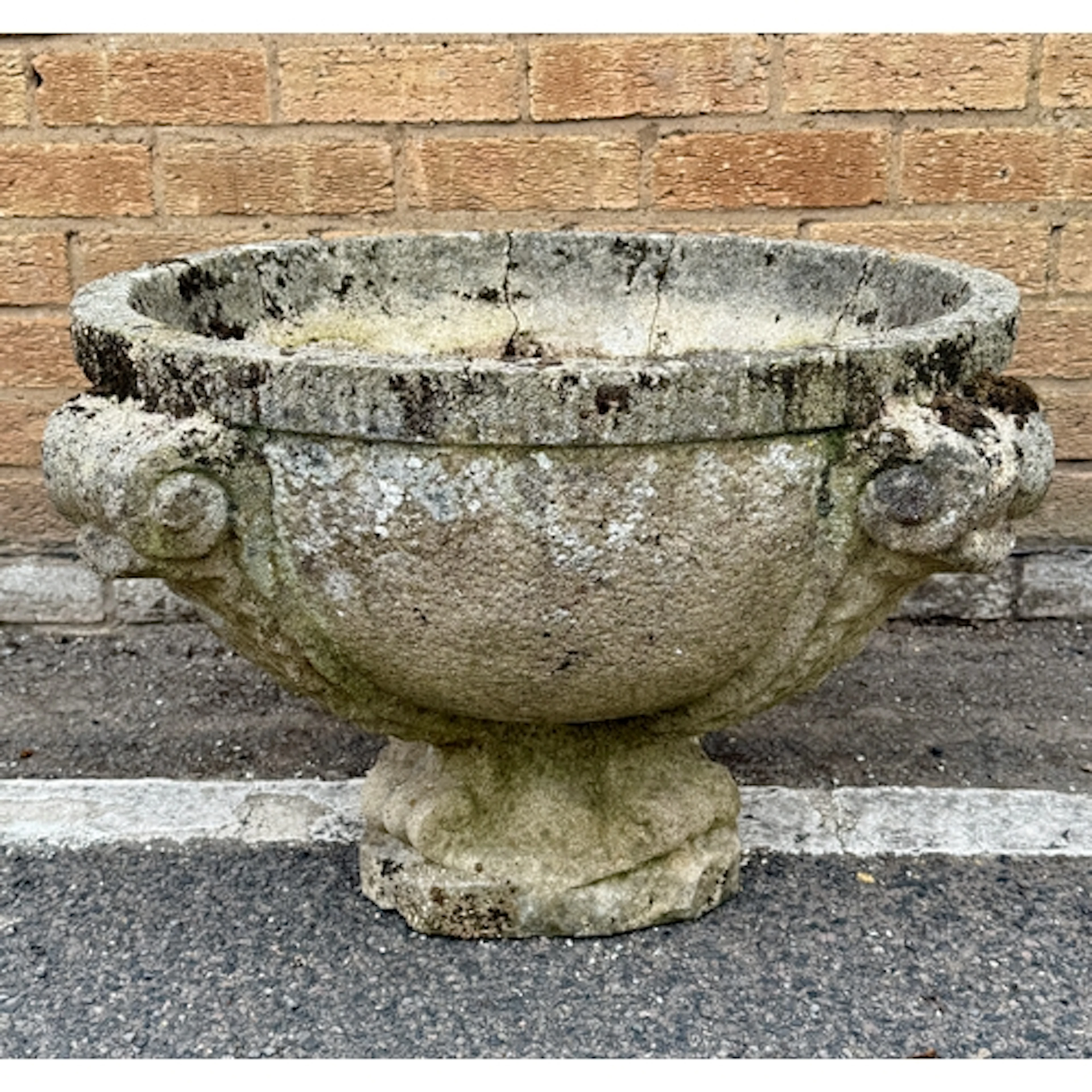 A large weathered composite stone neo-classical urn - with r...