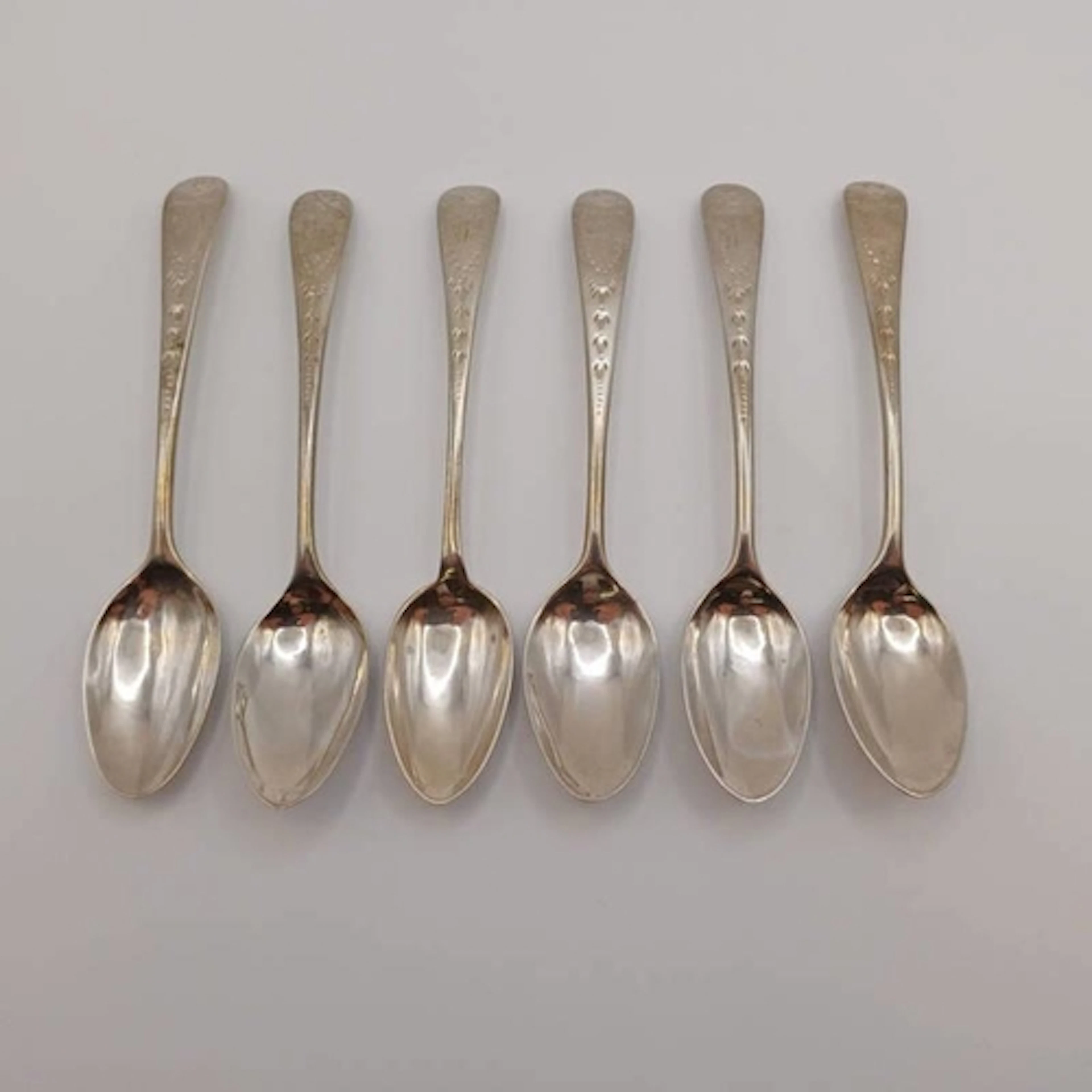 A SET OF 6 GEORGE III SILVER TEASPOONS WITH ENGRAVED HANDLES...