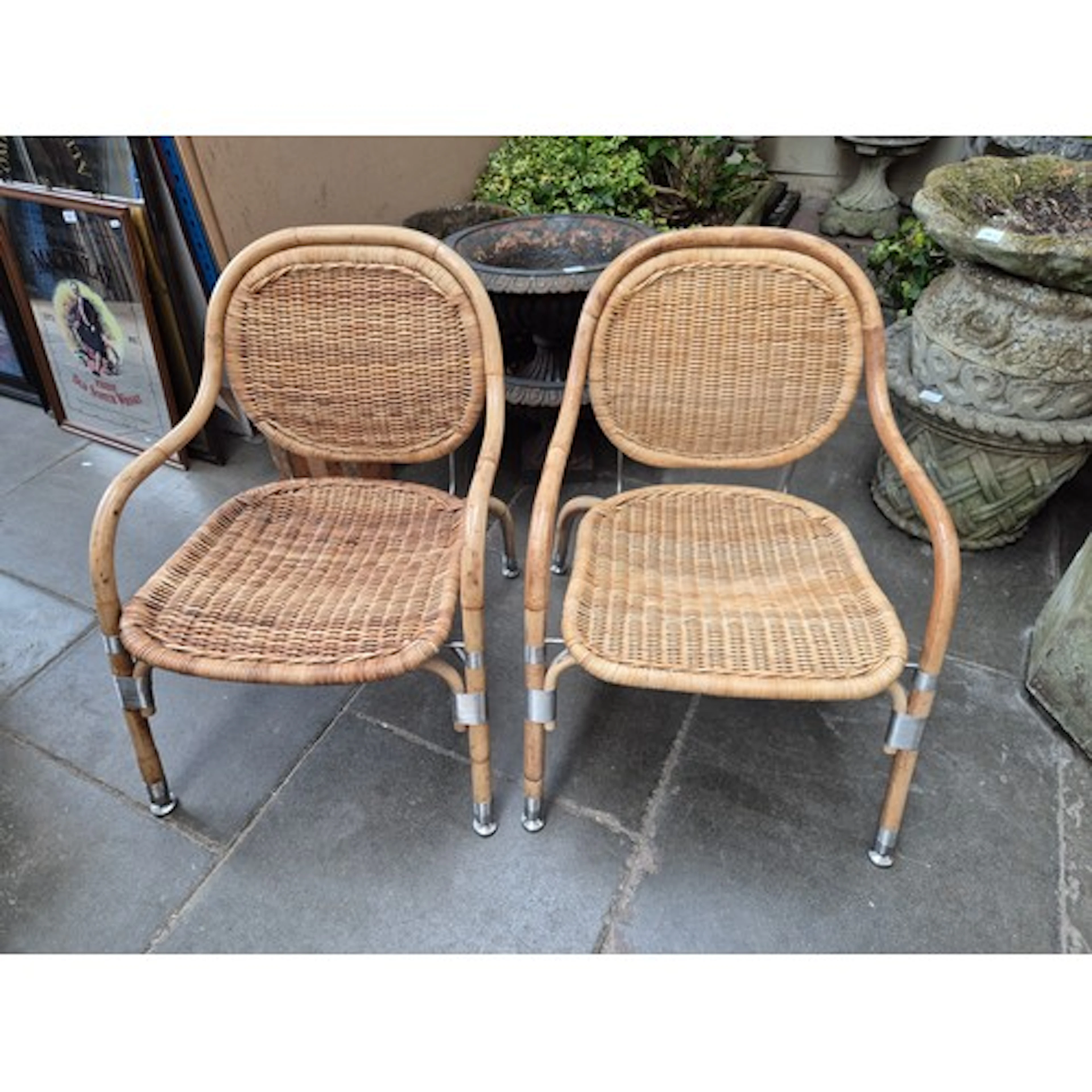 A pair of steel and cane wicker elbow chairs by Mats Theseli...