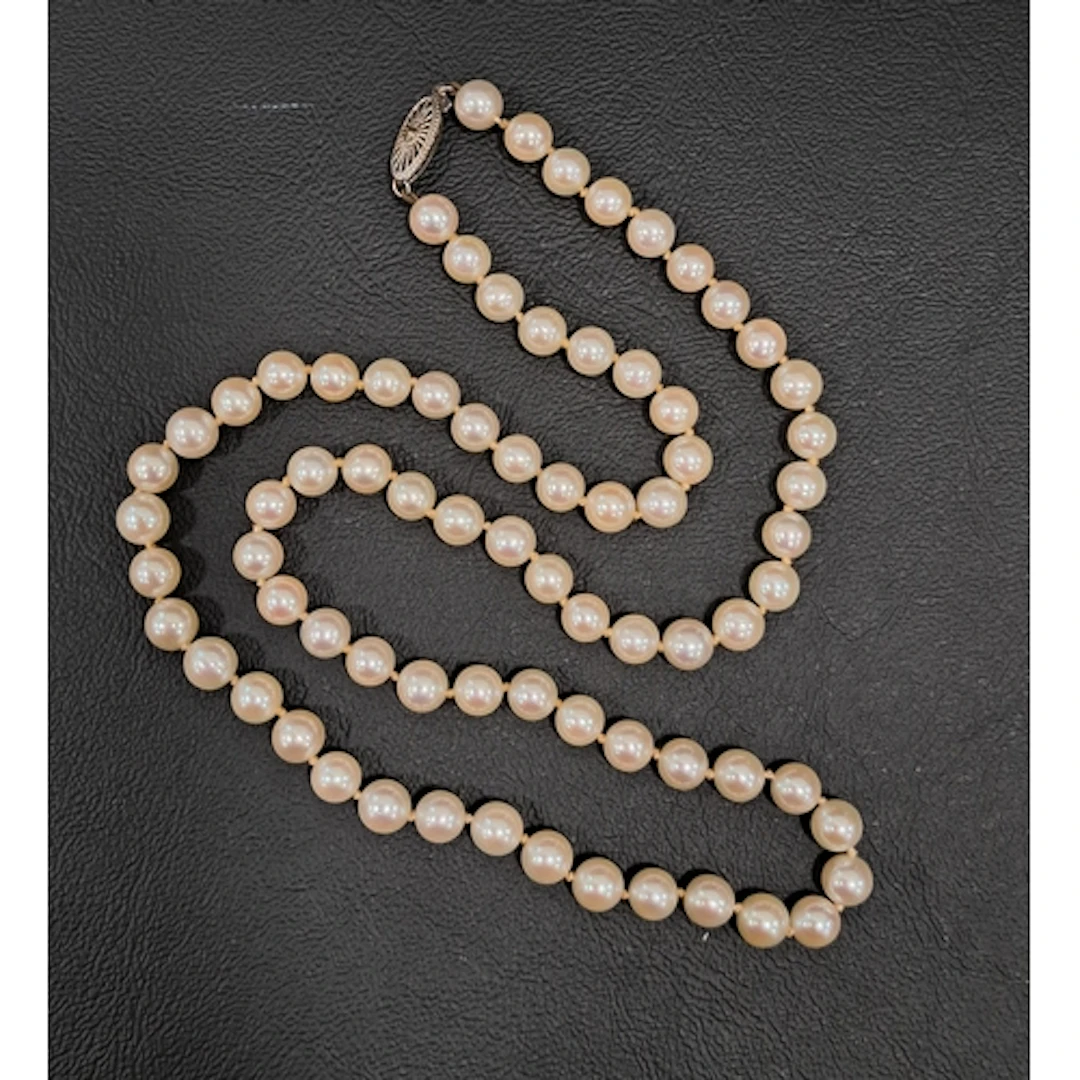 PEAL NECKLACE with pierced fourteen carat white gold clasp a...
