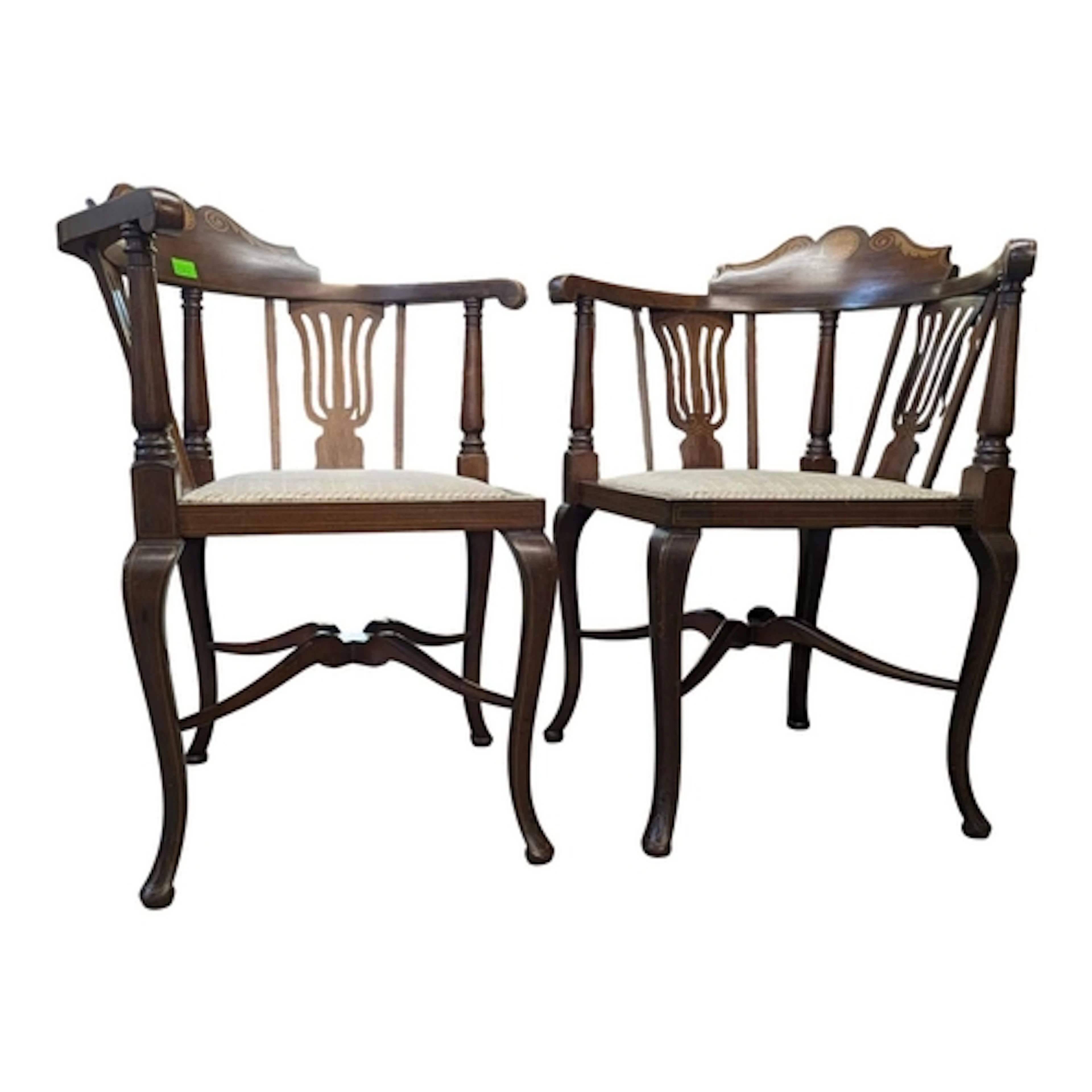 A pair of Edwardian mahogany corner chairs. Each armchair ra...