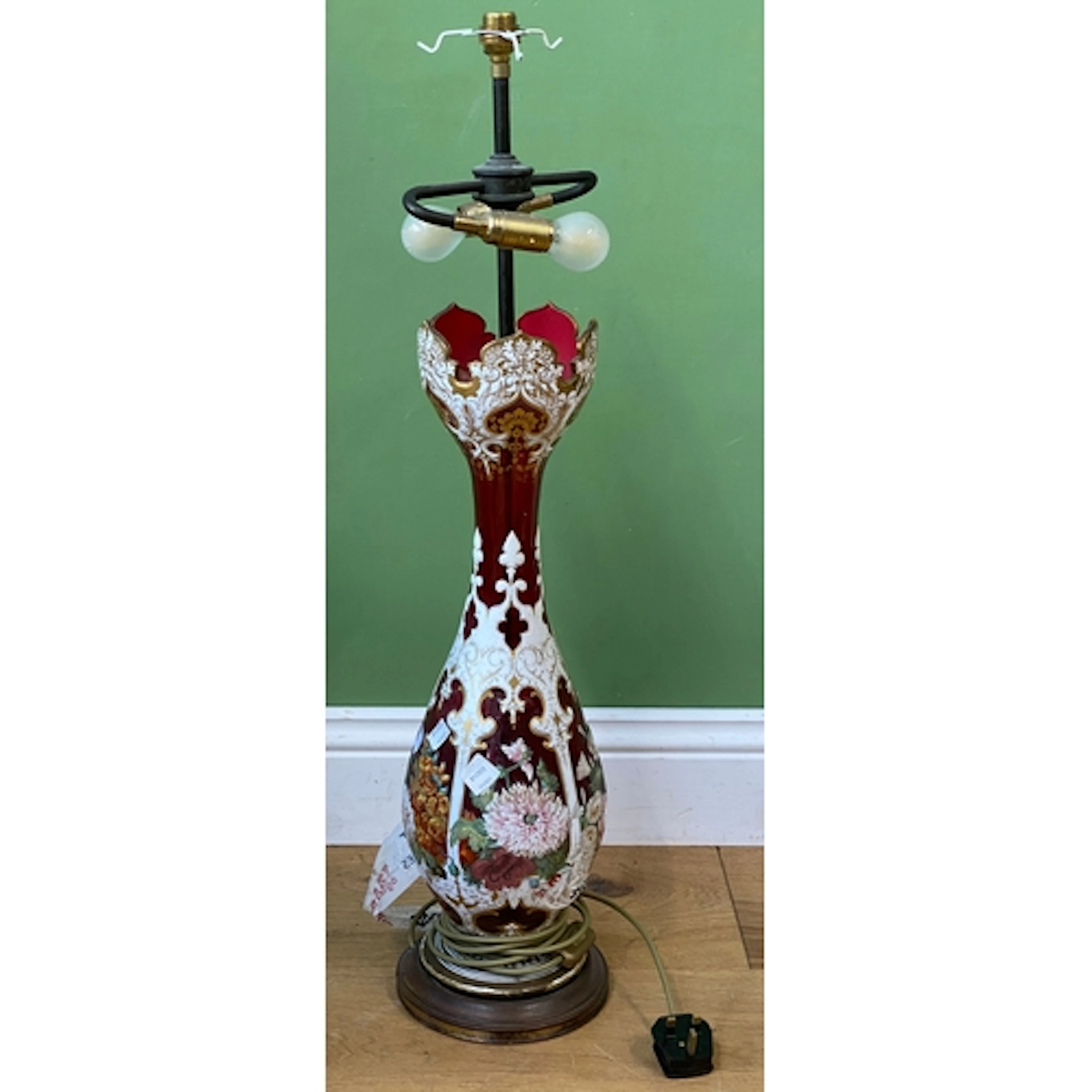 A bohemian cranberry and white flashed table lamp with flora...