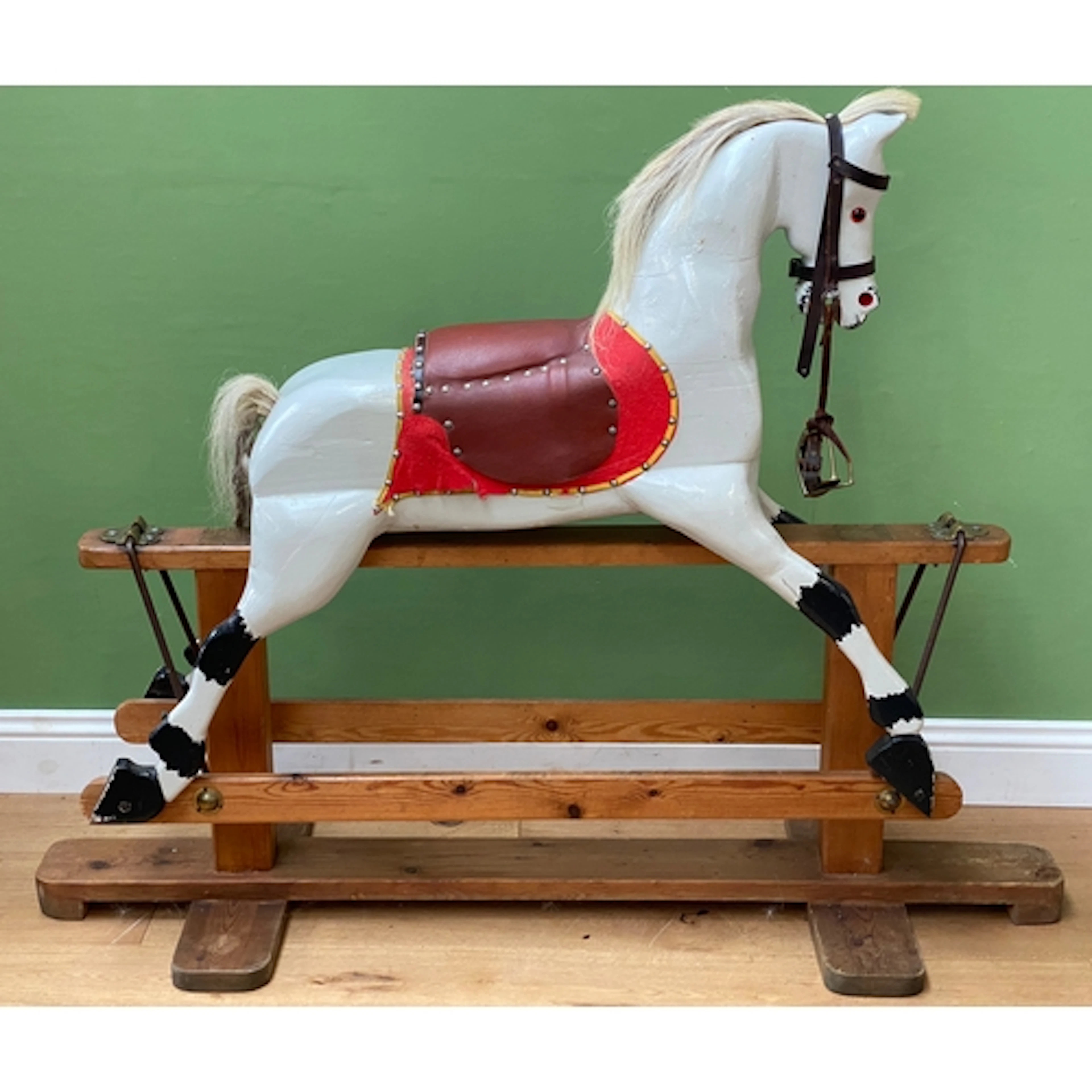 A large painted rocking horse on pine base, approx. 120cmH