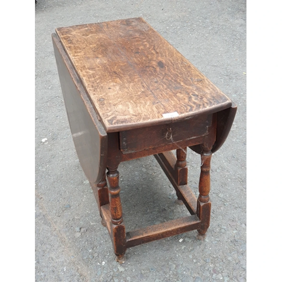 An oak gateleg Dining Table fitted single drawer with ring p...
