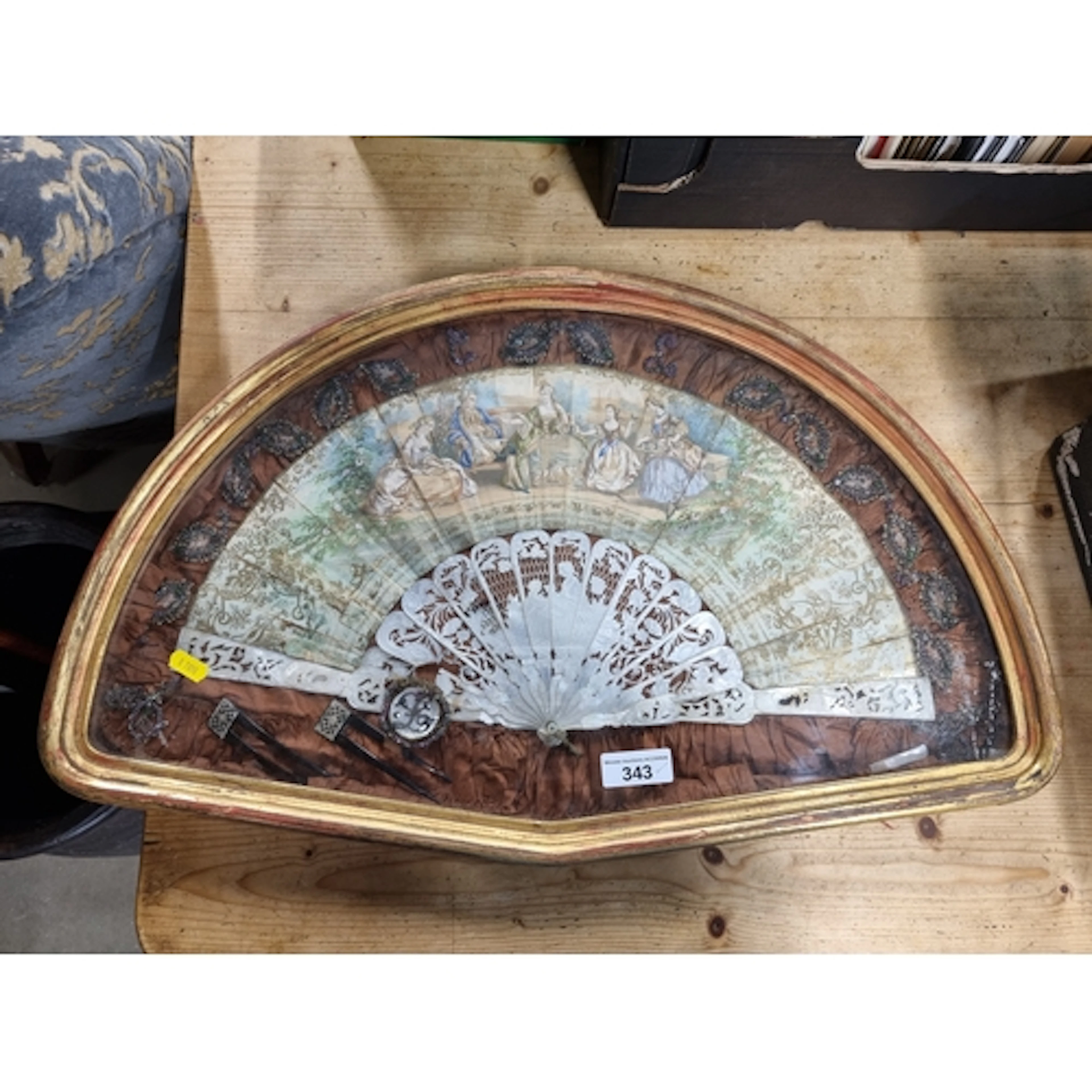 A folding paper Fan with pierced and engraved mother-of-pear...