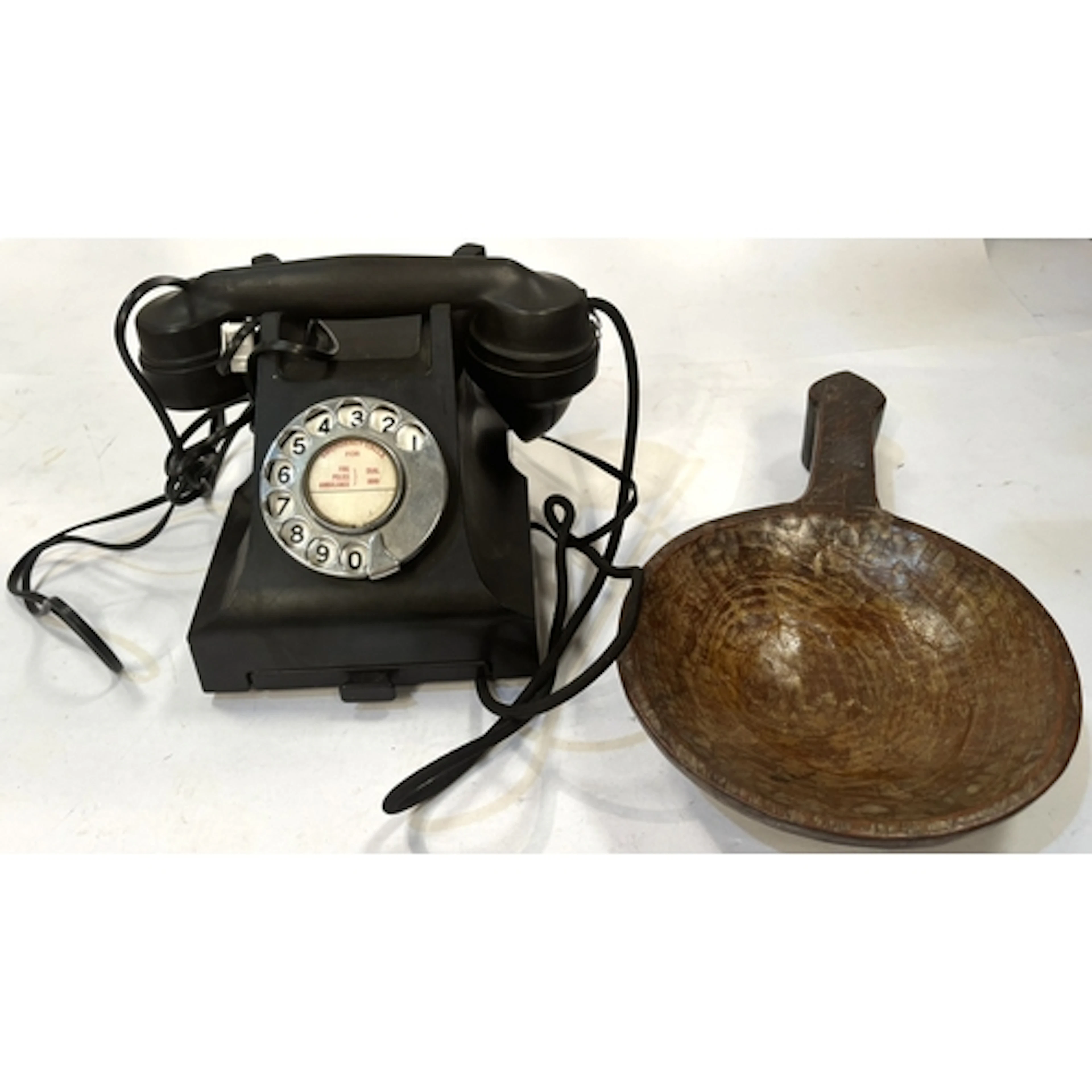 A mid-20th century Bakelite telephone; a treen bowl with han...