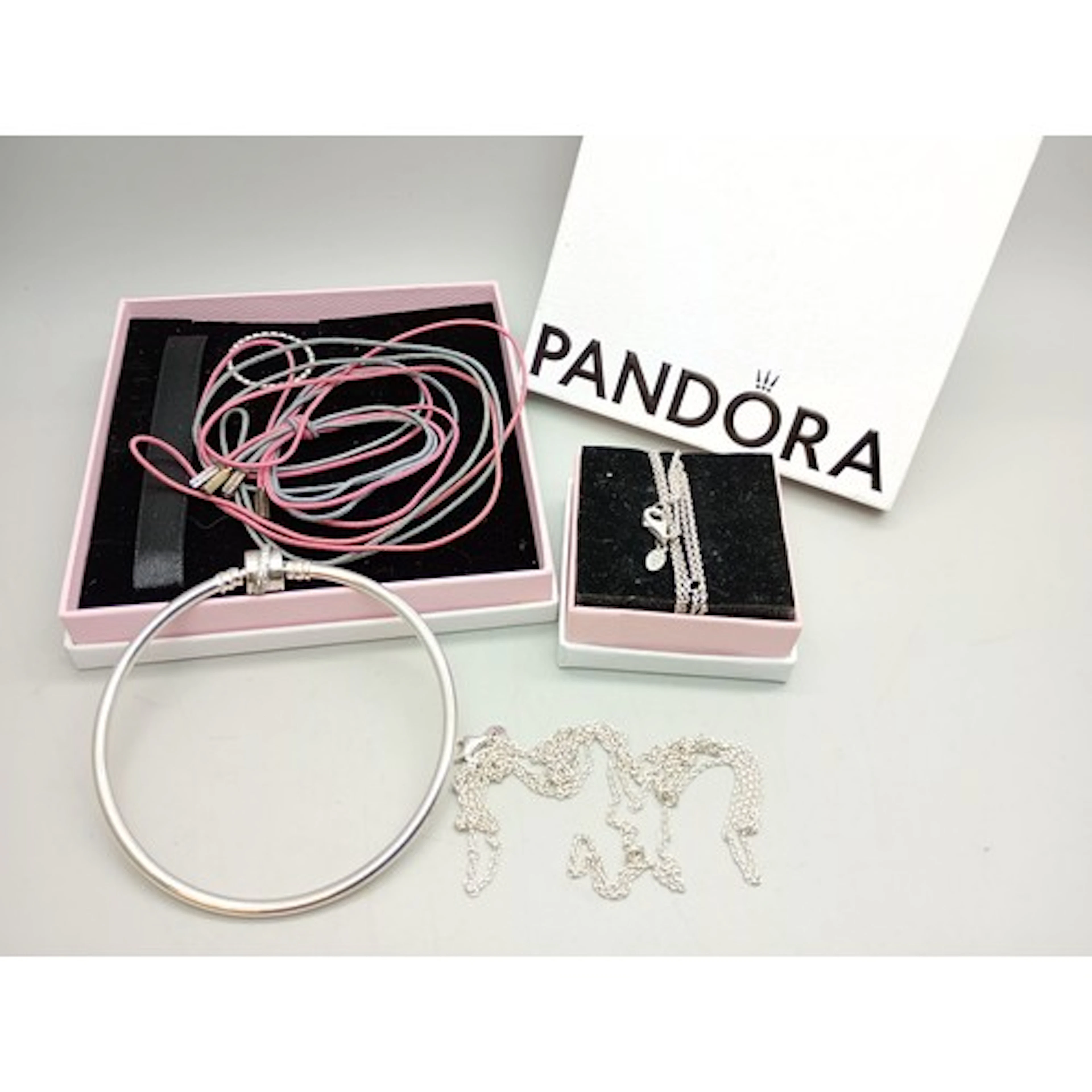 Two Pandora silver chains, a fabric necklace or bracelet, t...