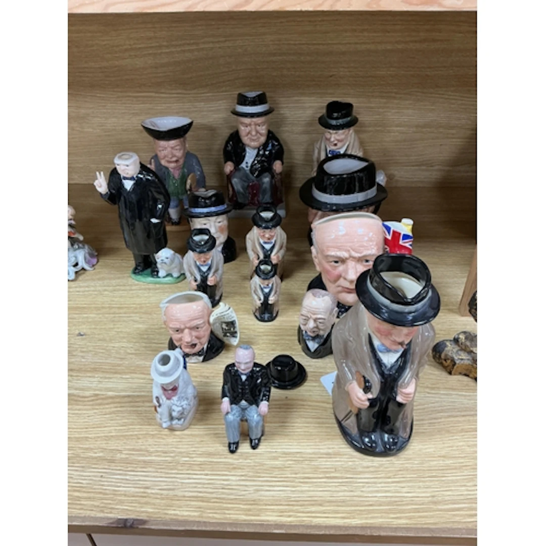 A collection of Winston Churchill character jugs and figures...