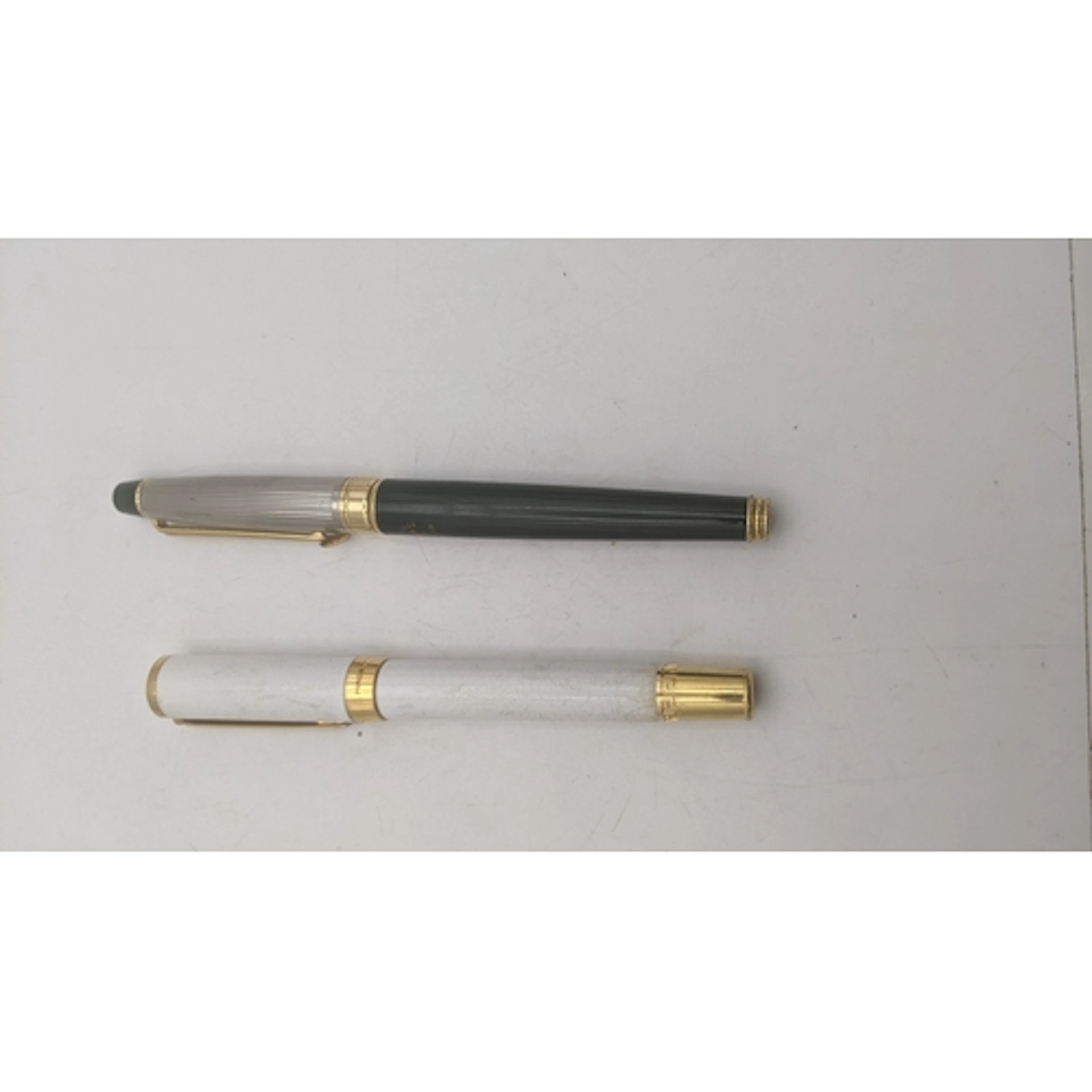 A Versace ballpoint pen along with a Beverly Hills ballpoint...
