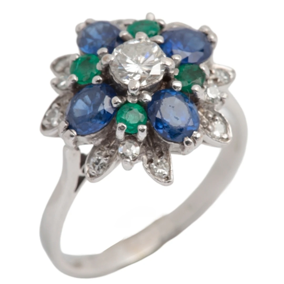 A diamond, sapphire and emerald cluster ring, centring on a ...