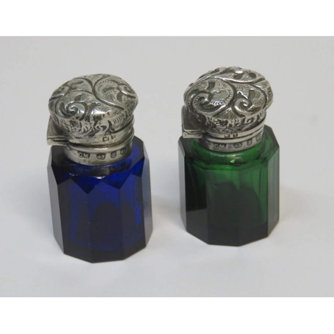 Two late 19th Century silver topped blue and green coloured ...