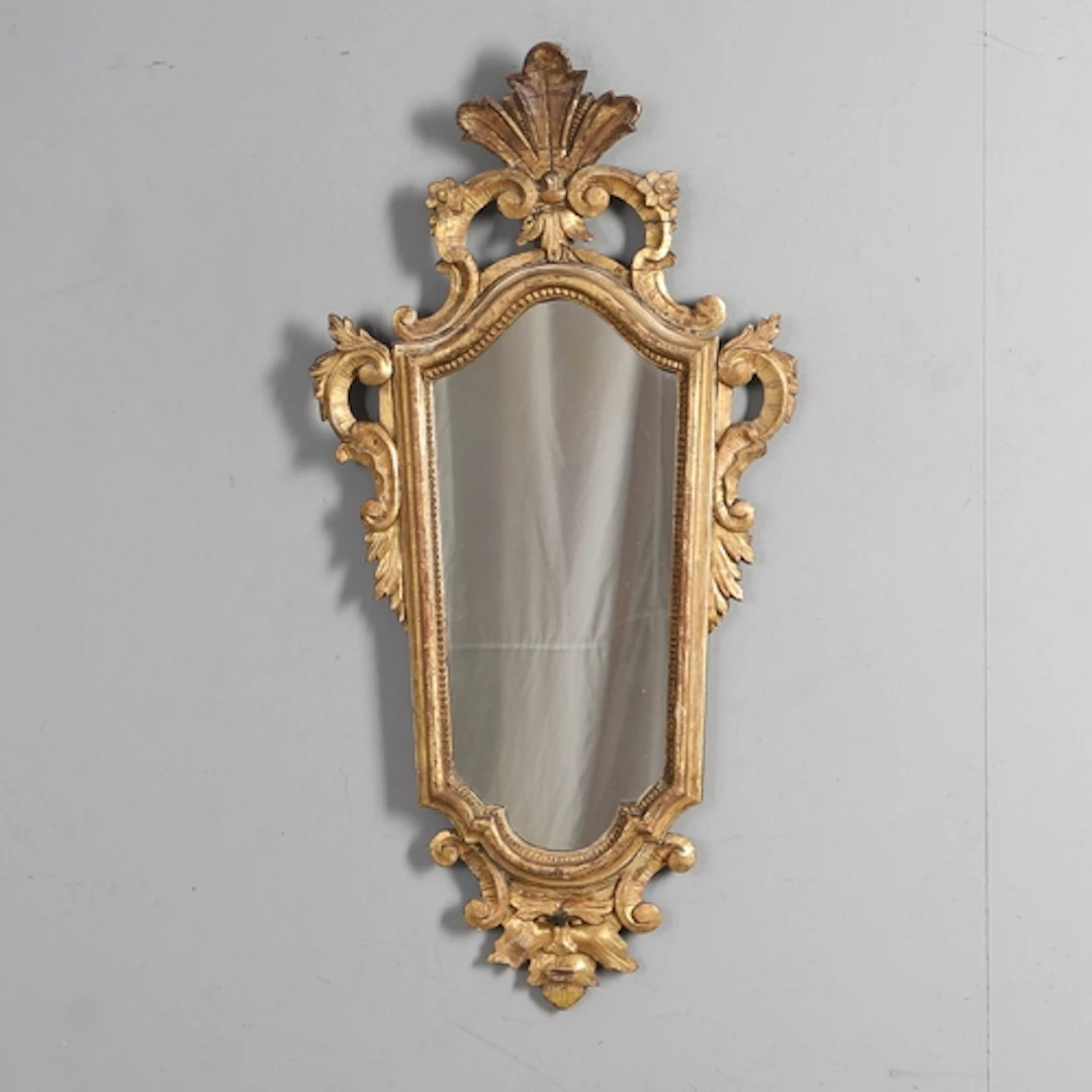 AN 18TH CENTURY ITALIAN GILTWOOD GIRANDOLE. the later taperi...