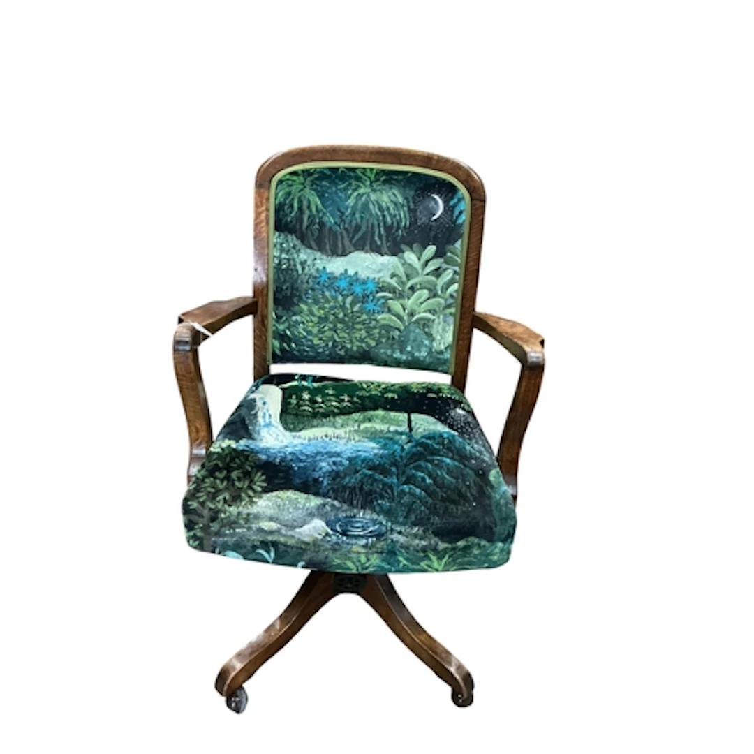 An early 20th century oak swivel desk chair upholstered in c...