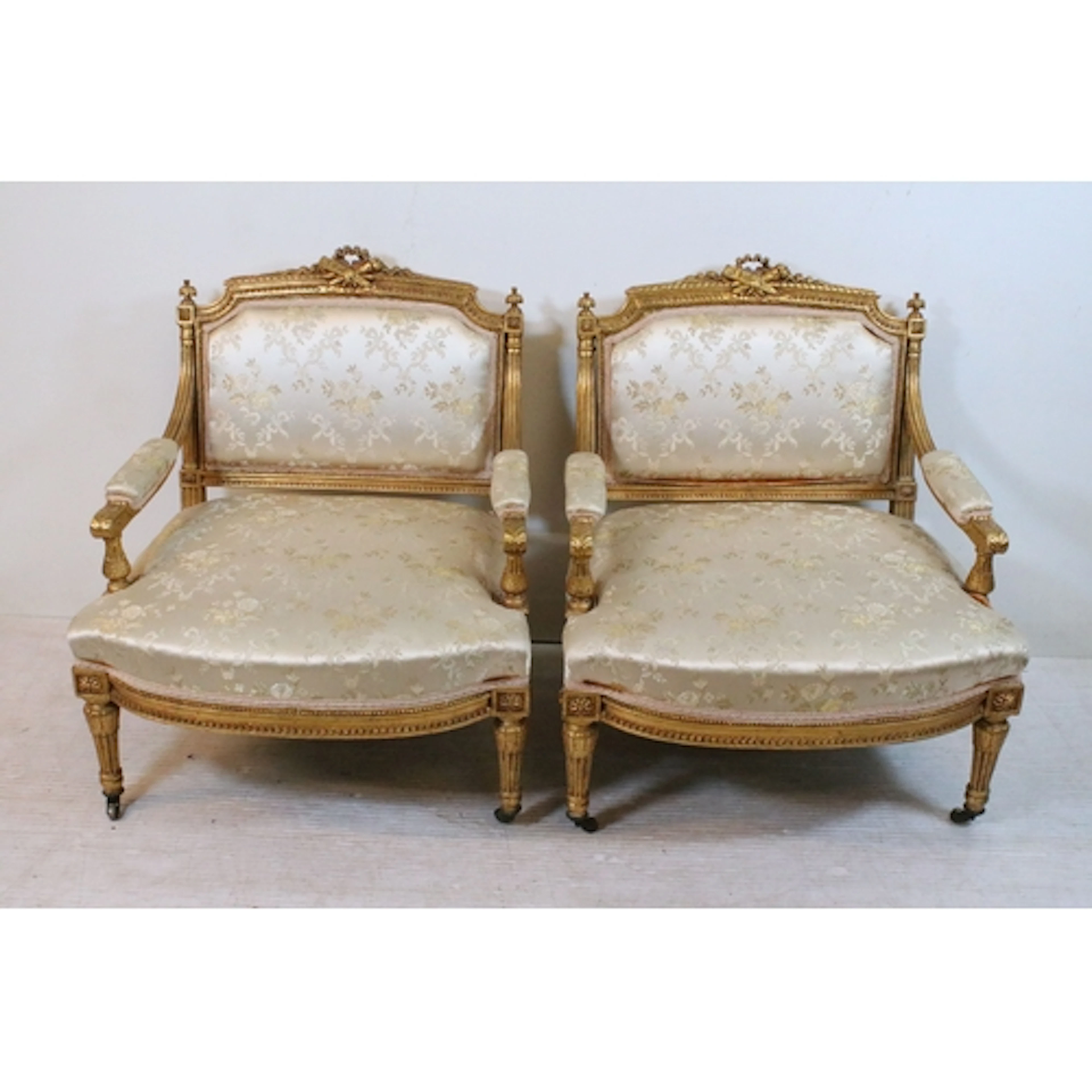 Pair of Louis XVI style giltwood open armchairs, each with c...