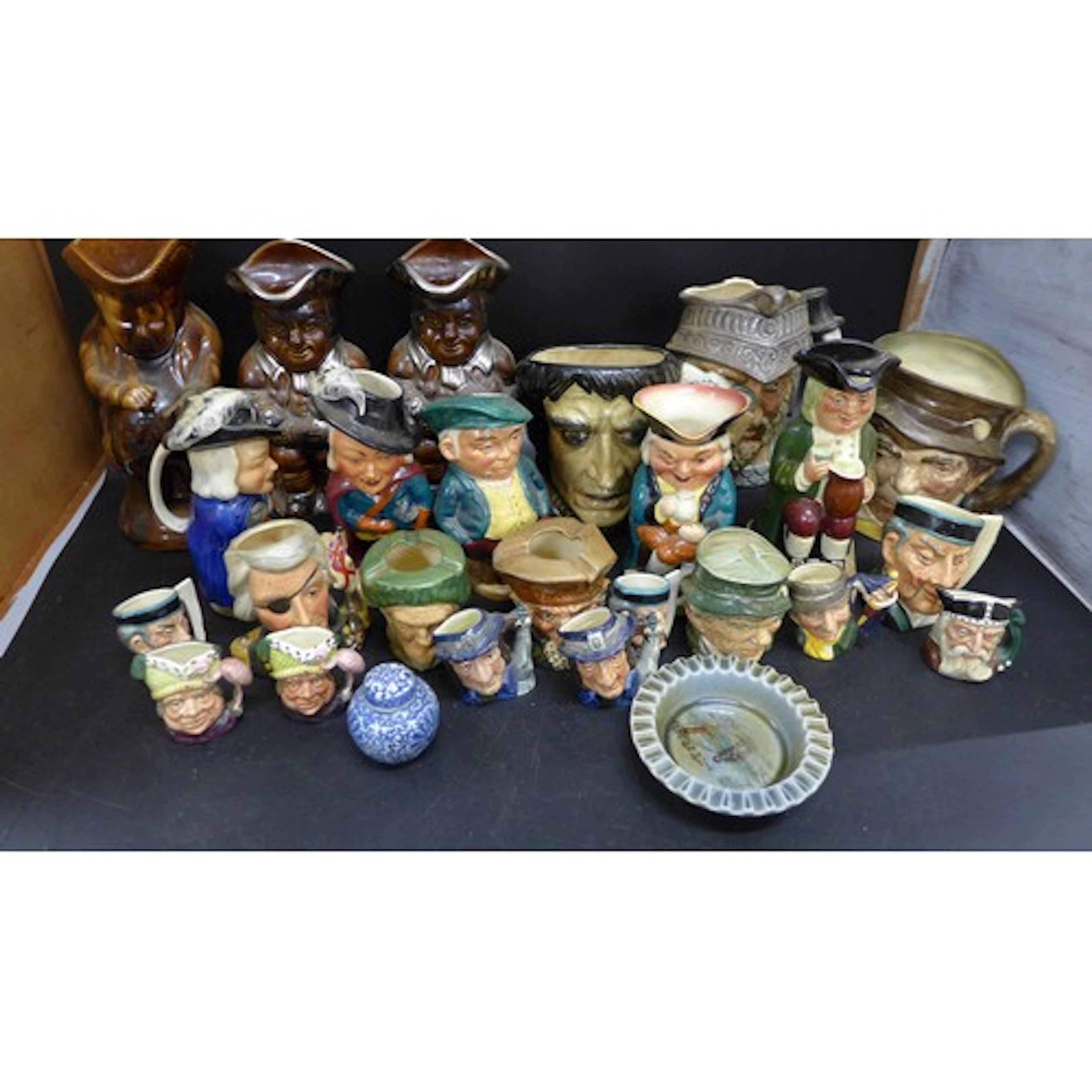 A collection of character Toby Jugs and ashtrays, to include...