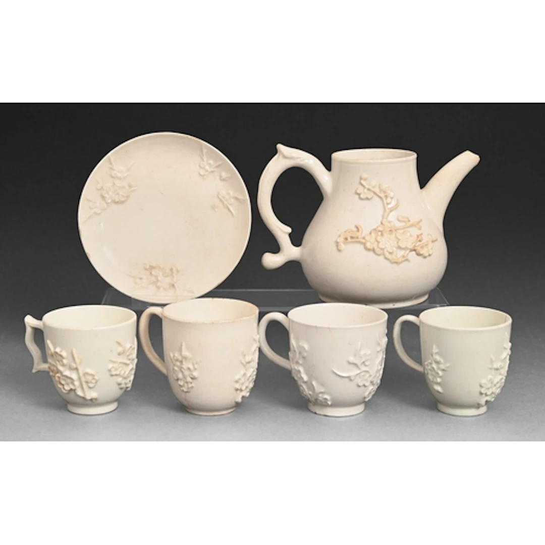 A Bow prunus sprigged teapot, four coffee cups and a saucer,...