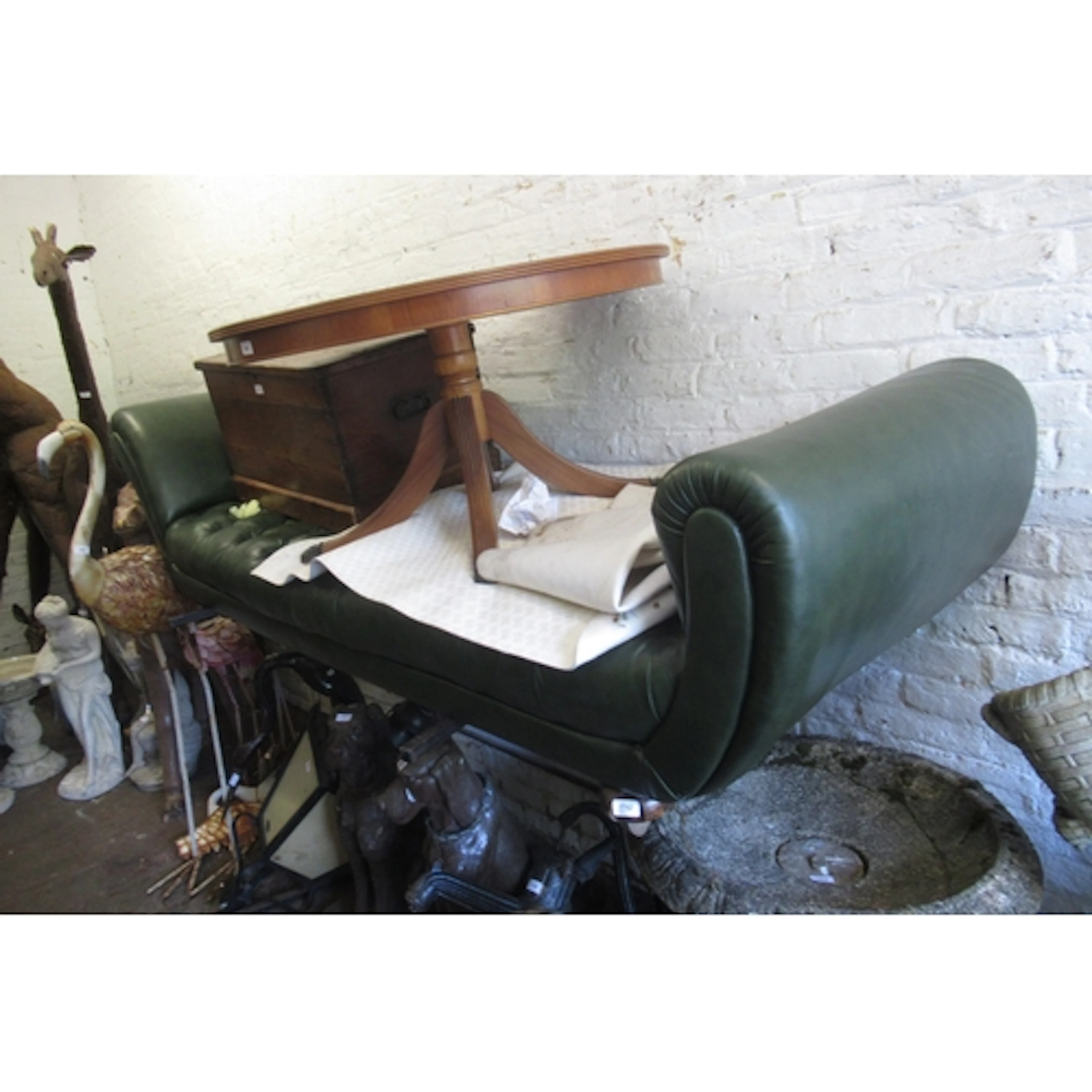 Large green buttoned leather upholstered chaise longue, on l...
