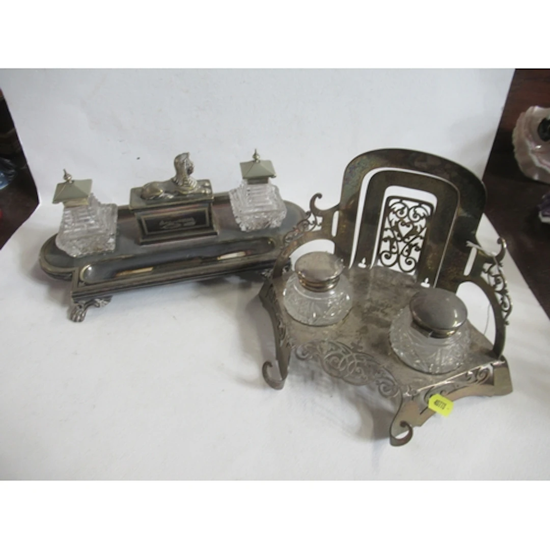 A silver plated desk stand, with Egyptian decoration, togeth...