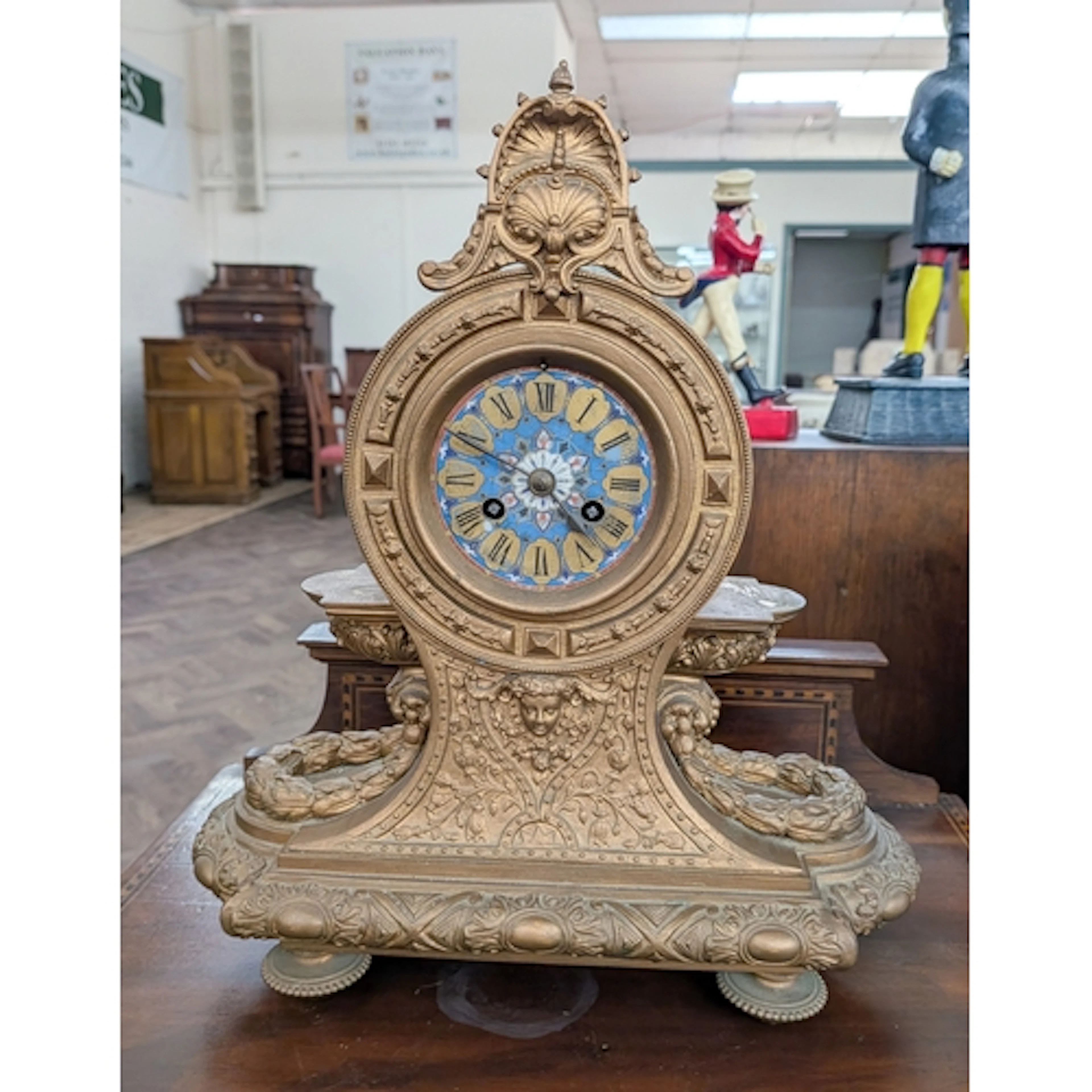 A decorative French gilt metal mantle clock with painted dia...