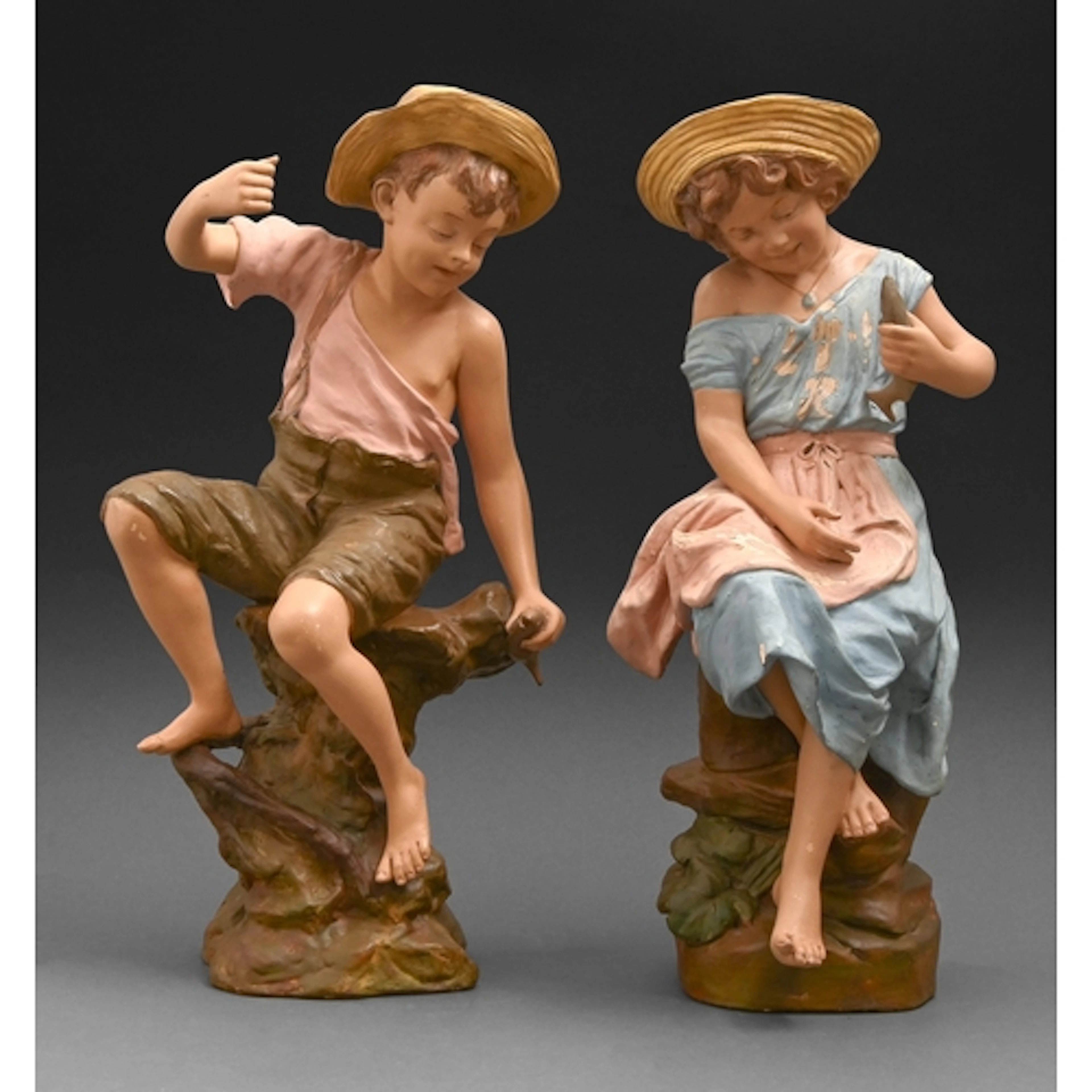 A pair of Goldscheider cold painted terracotta figures of a ...