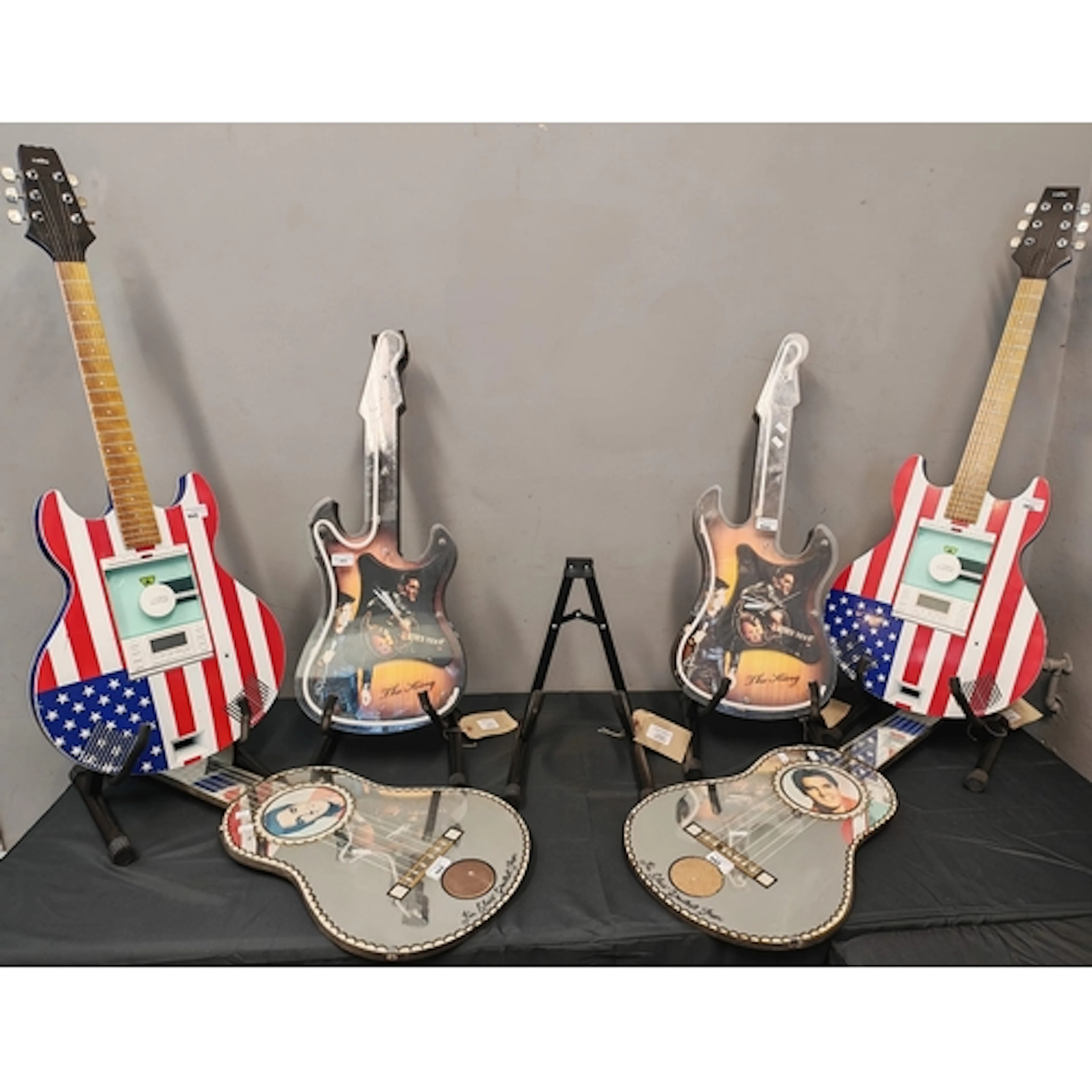 Collection of Elvis Presley wall clocks and CD players in th...
