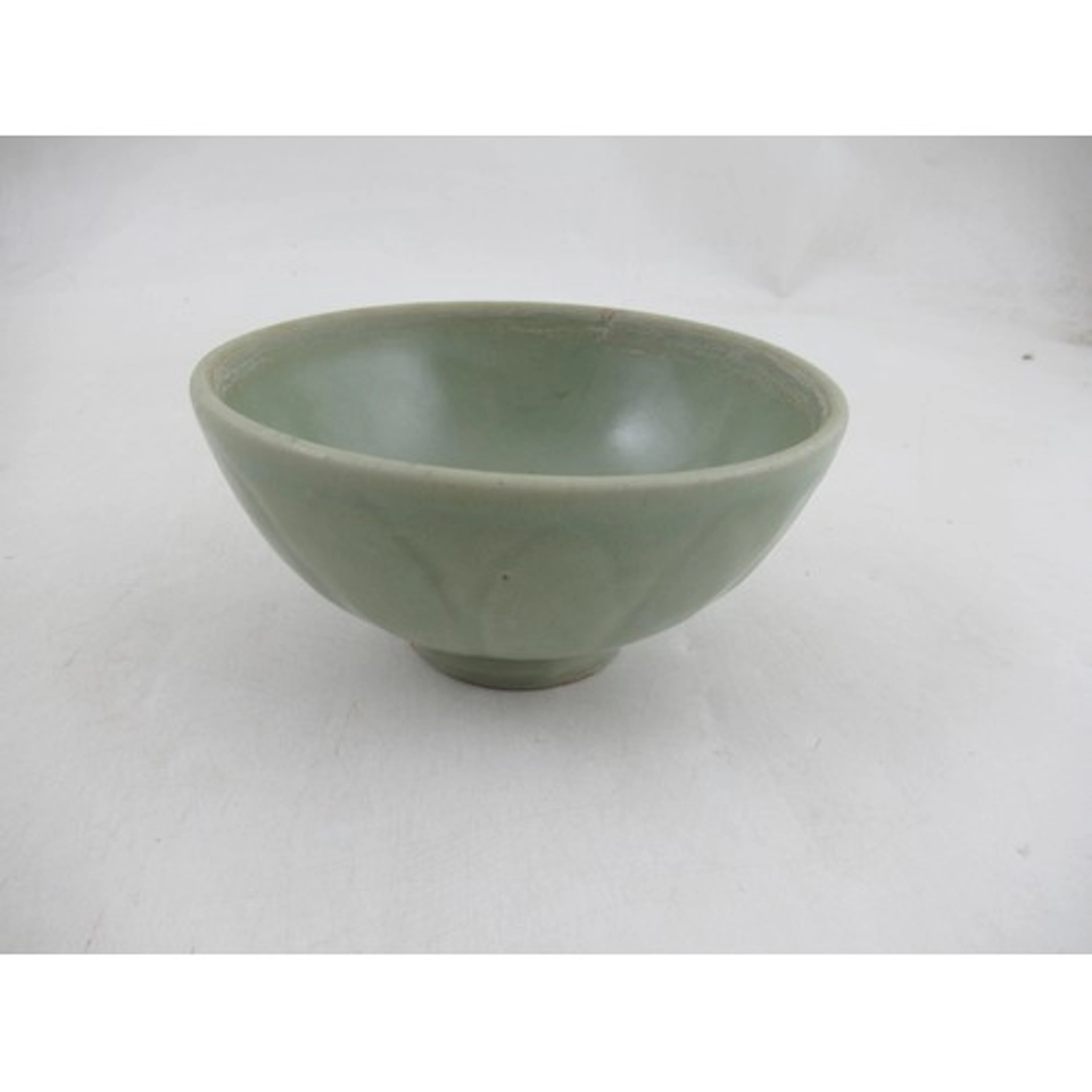 A celadon bowl, decorated with molded leaves, diameter 5.5in...