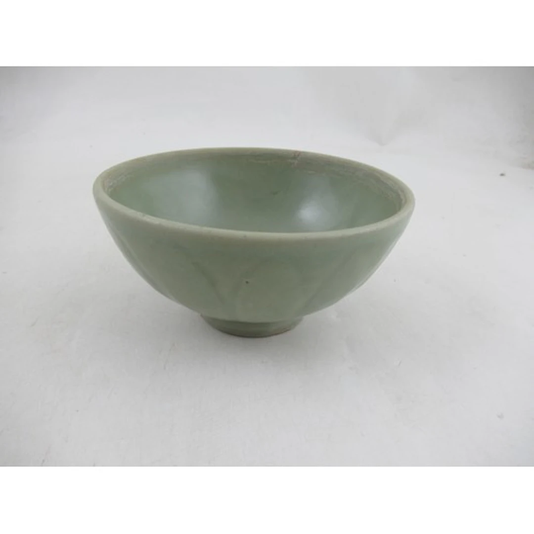 A celadon bowl, decorated with molded leaves, diameter 5.5in...