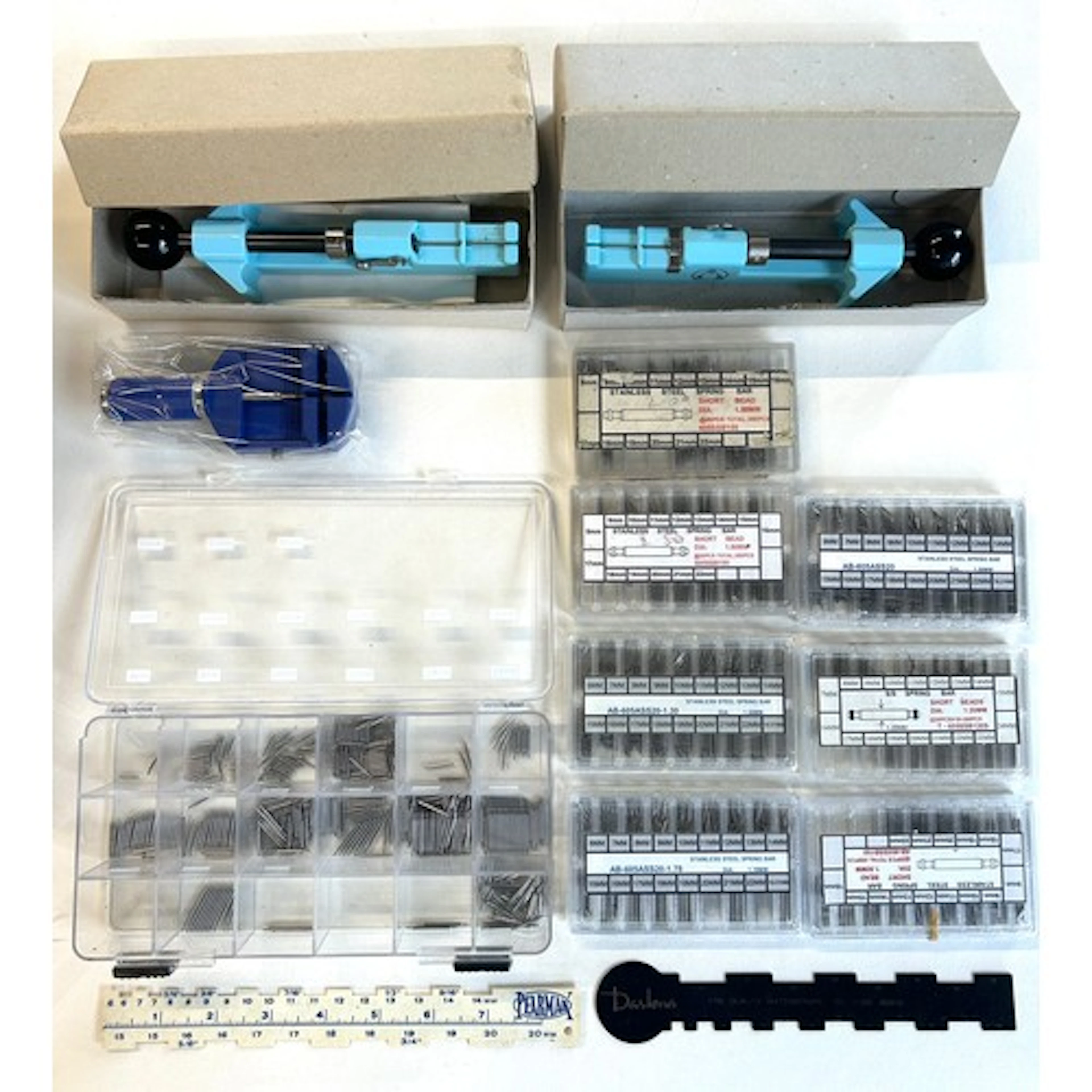 Assortment of wrist watch strap accessories and tools. To in...