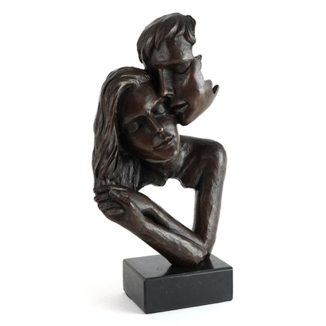 Patinated bronze sculpture of a loving couple raised on a bl...