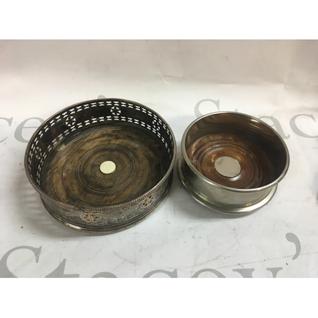 A pair of silver plated wine coasters