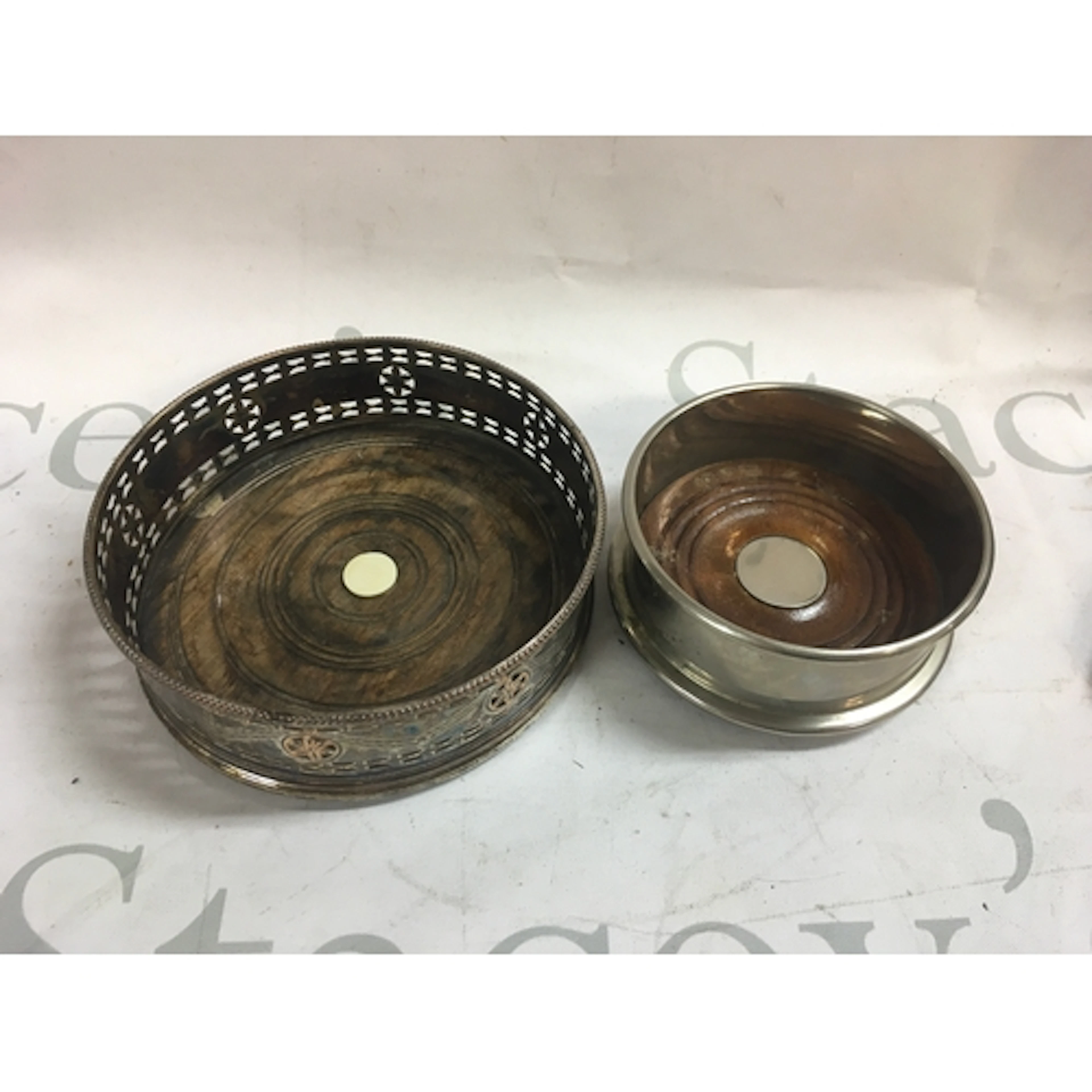 A pair of silver plated wine coasters