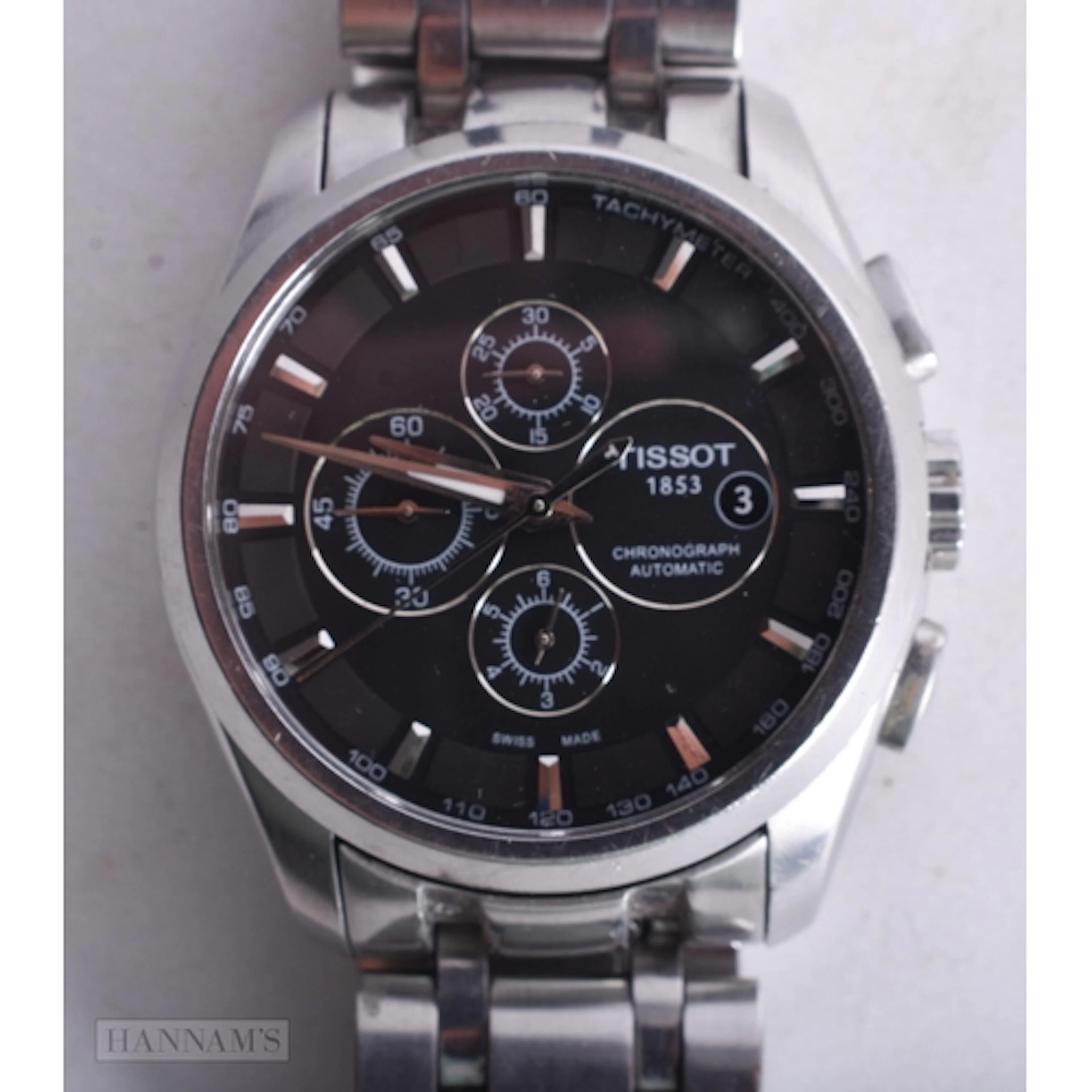 A TISSOT WRIST WATCH. Running. 4 cm wide.