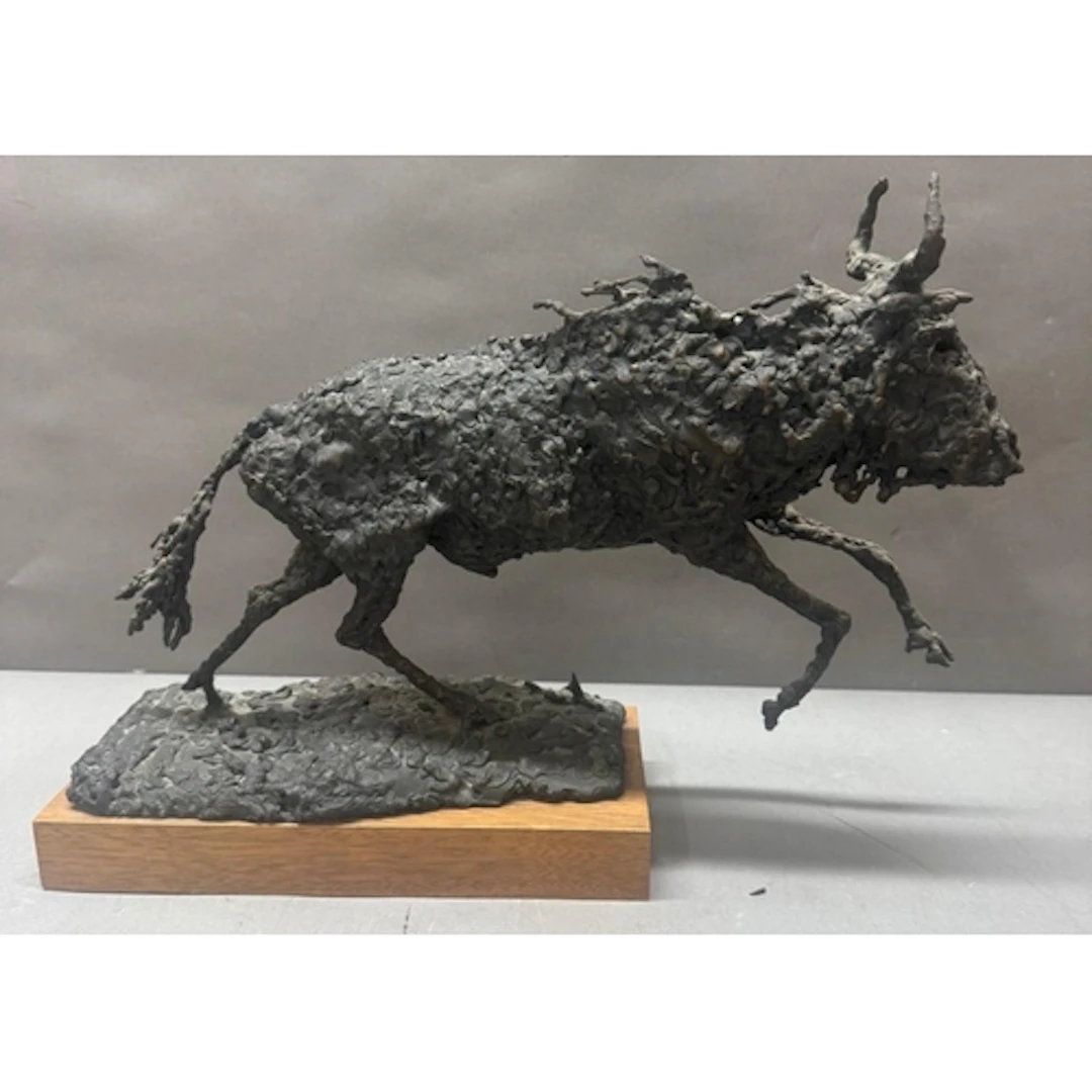 A bronze sculpture of a water buffalo on plinth. Length 43cm...