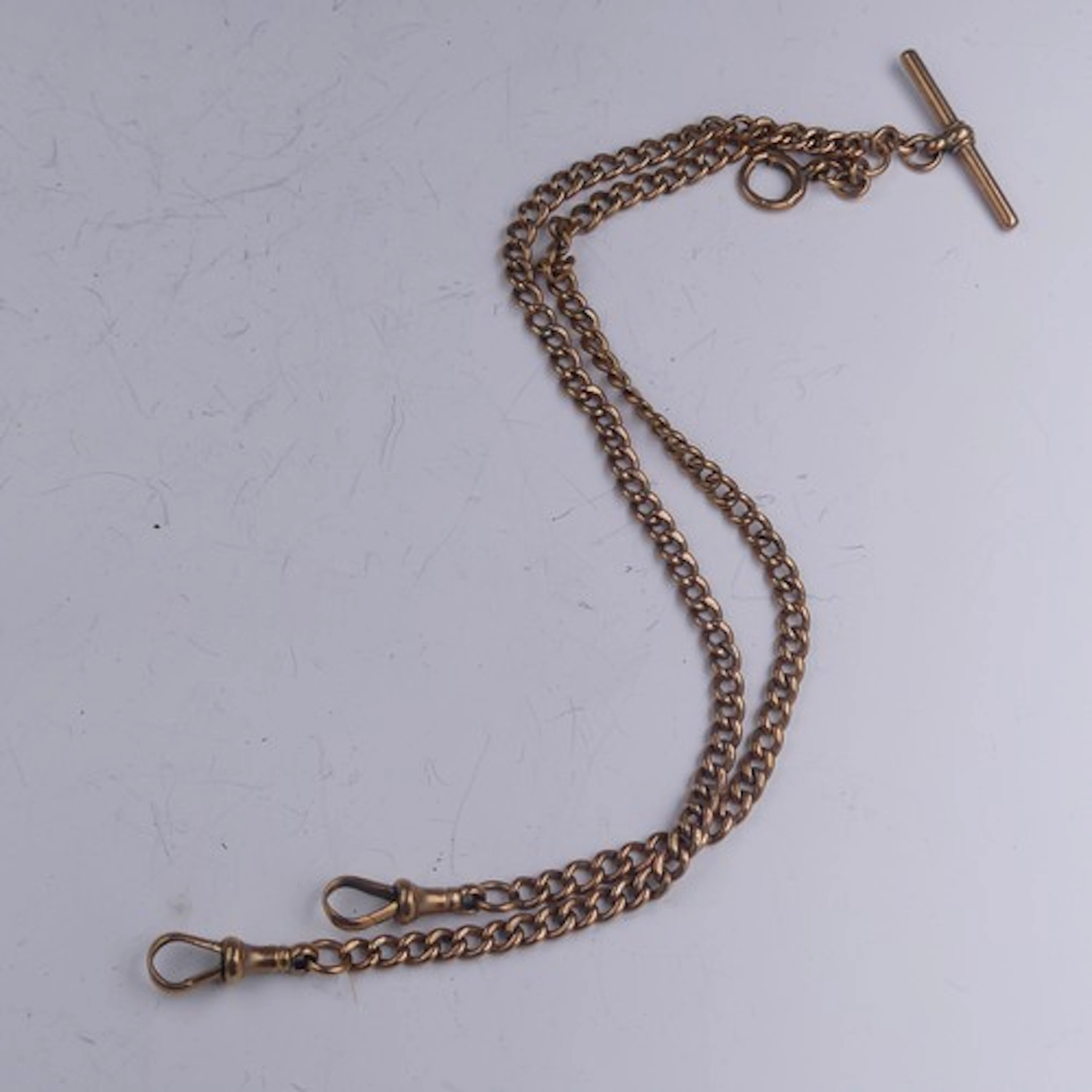 A 9ct gold curb link Watch Chain, with a dog clip at either ...