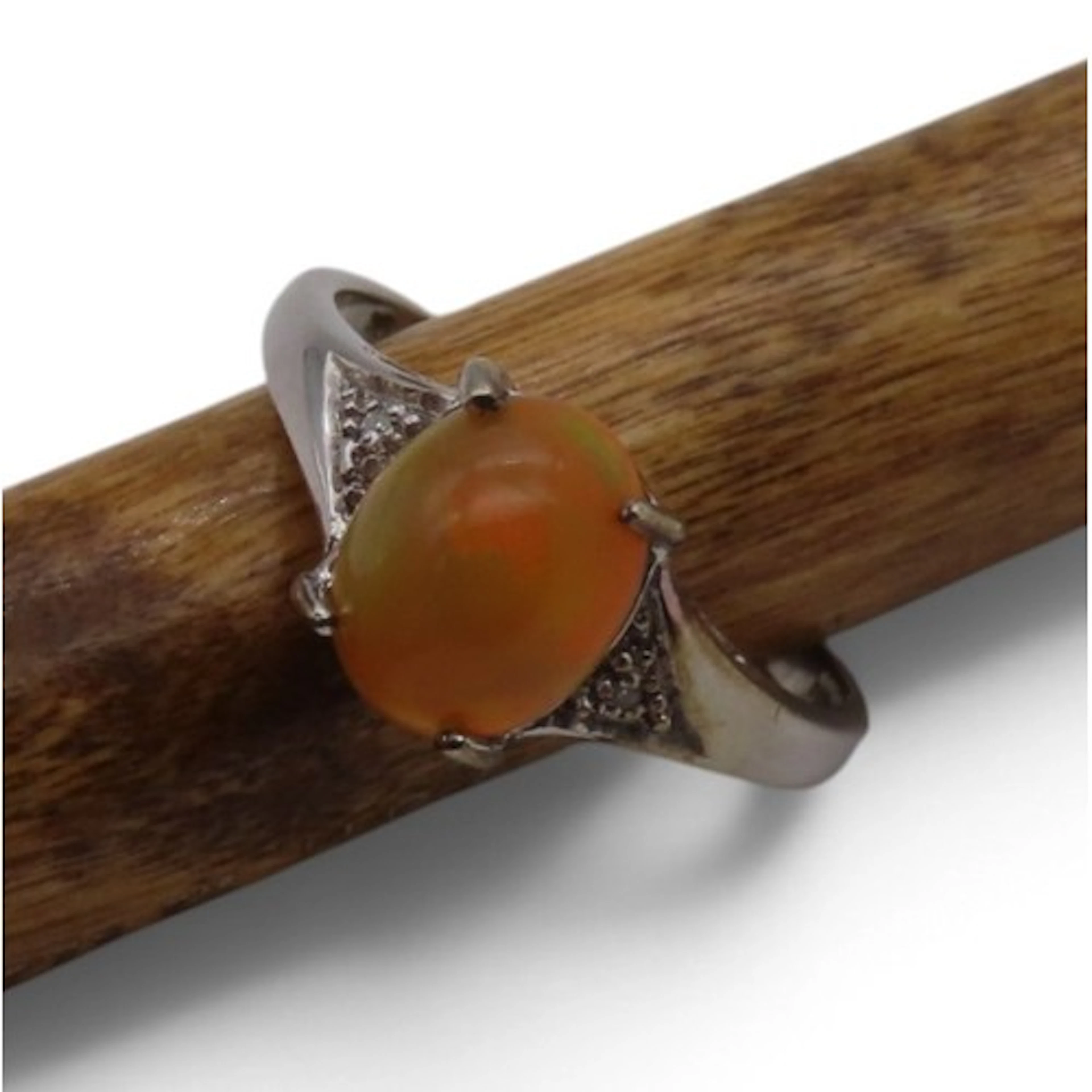 A fire opal and diamond ring, by Rocks & Co., set with an ov...