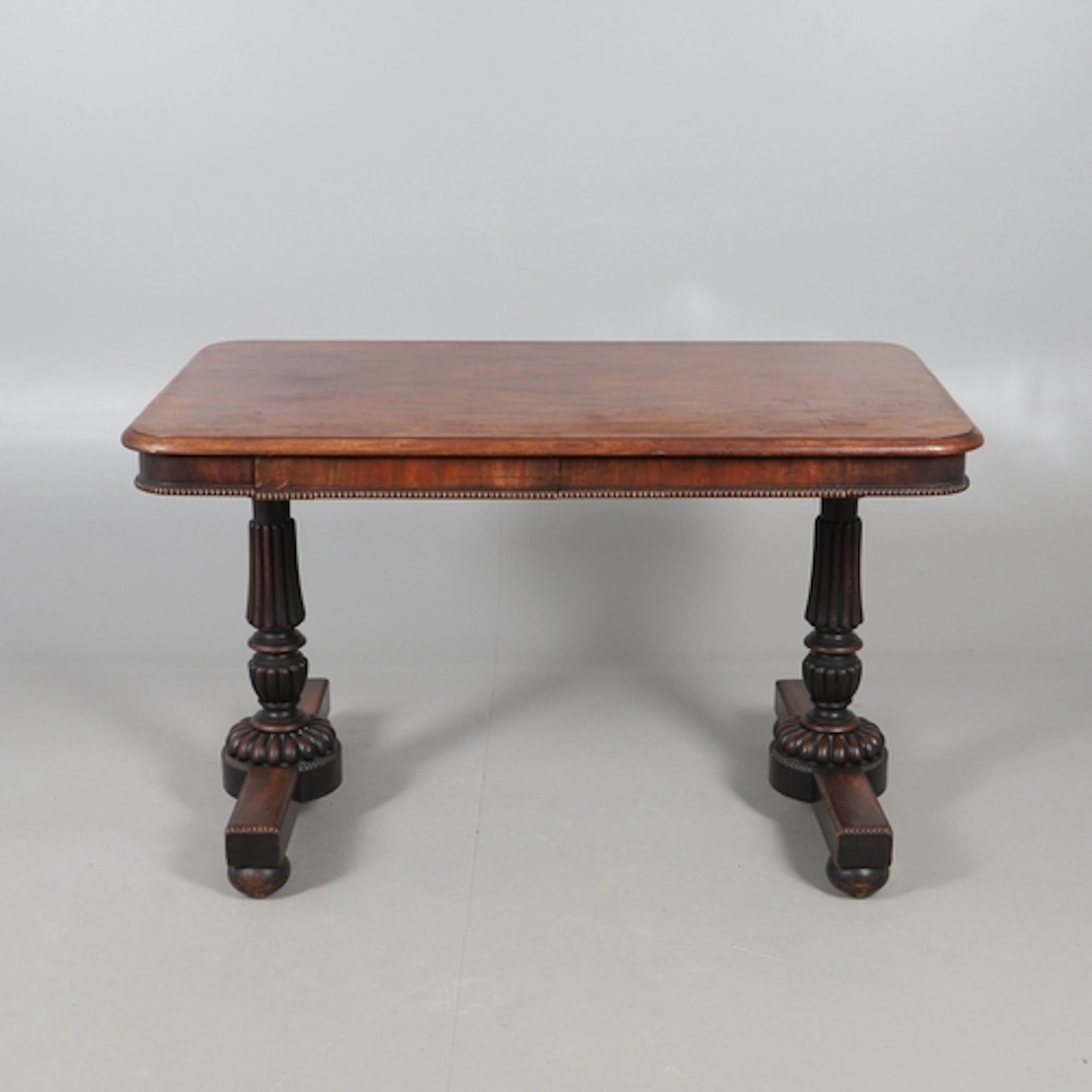 A REGENCY MAHOGANY LIBRARY TABLE, IN THE MANNER OF GILLOWS. ...